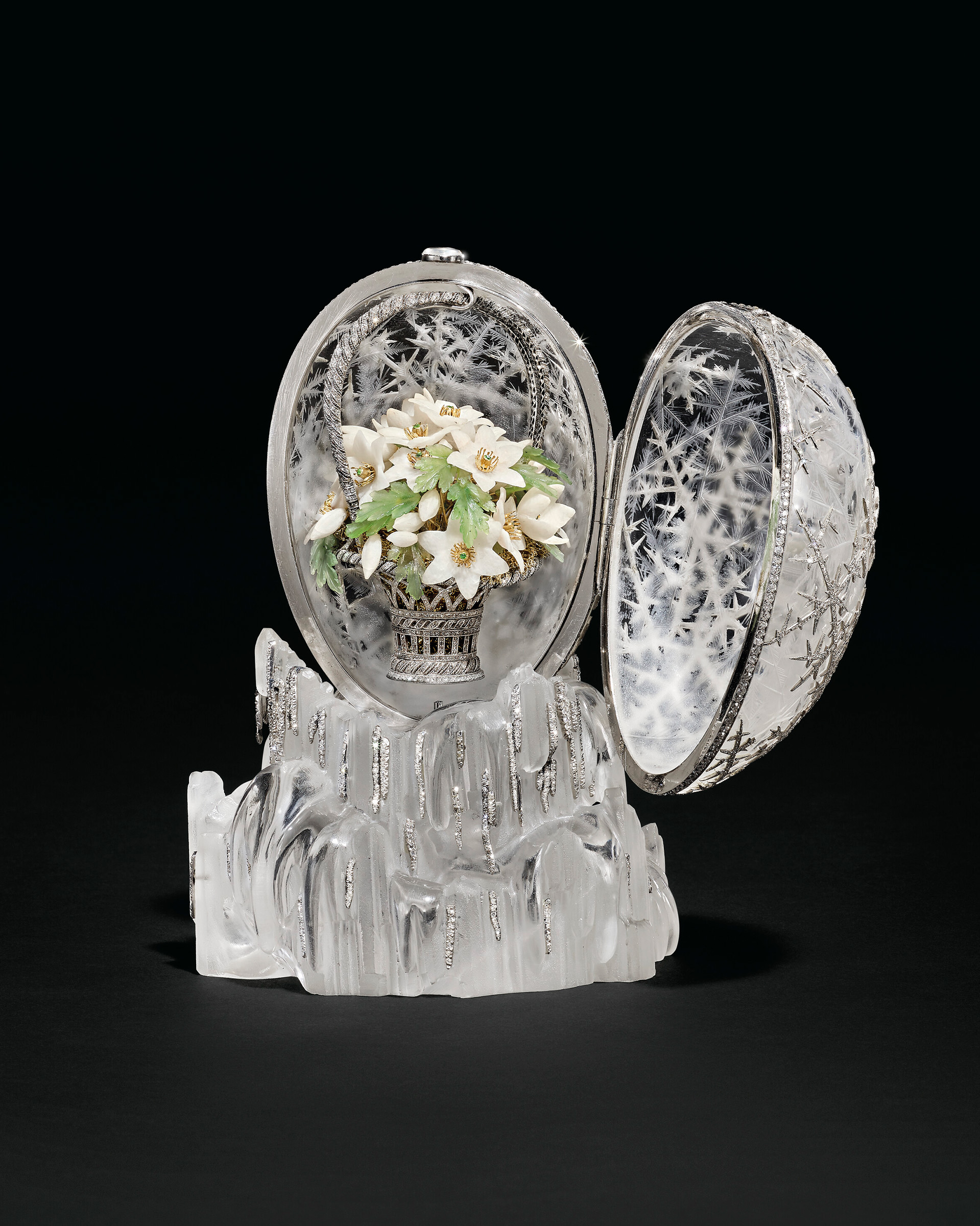 The egg opens to reveal a double-handled trelliswork platinum basket, set throughout with rose-cut diamonds, filled with finely carved white quartz wood anemones, each with gold wire stem and stamens. Offered in The Winter Egg and Important Works by Faberge from a Princely Collection on 2 December 2025 at Christie's in London