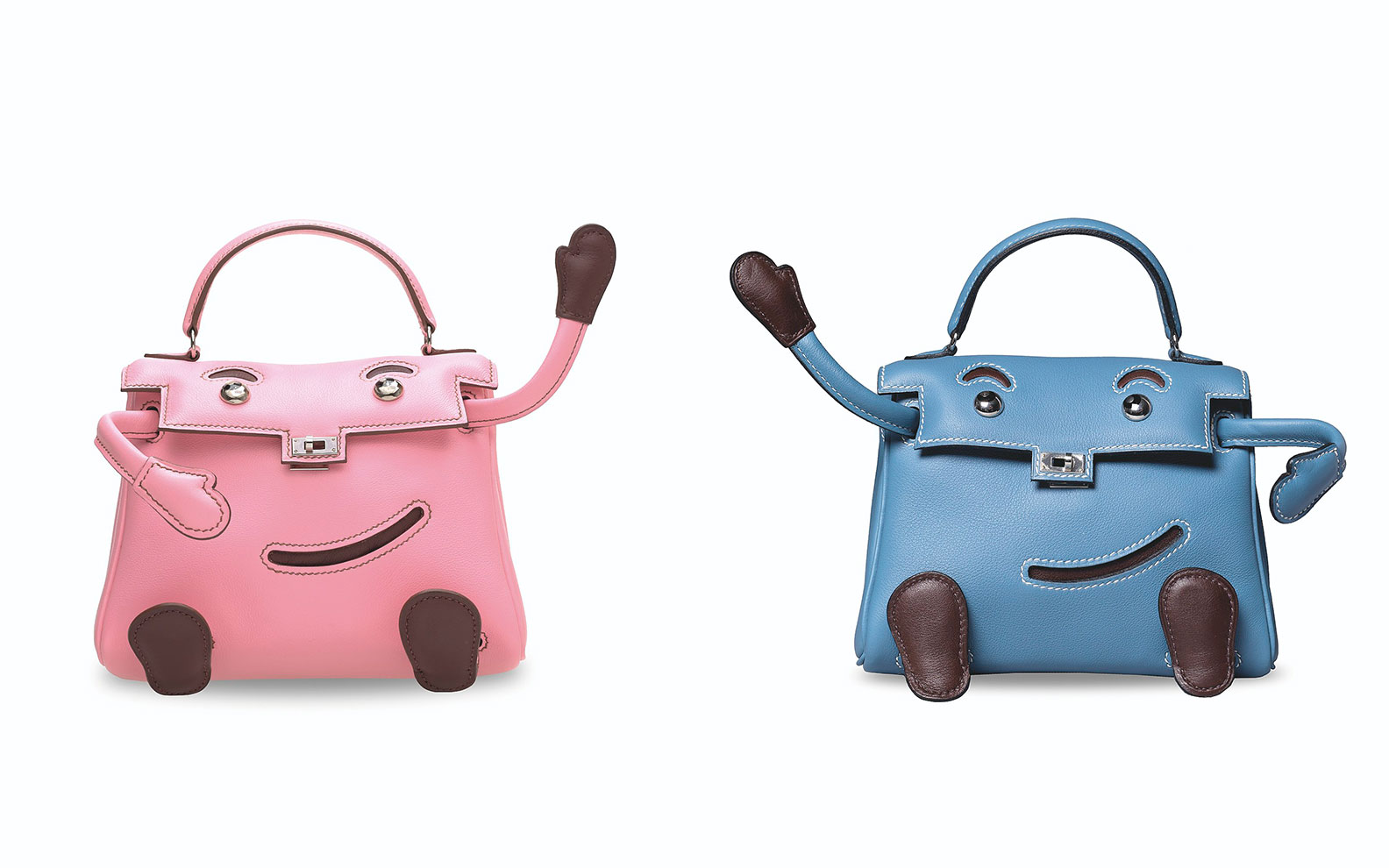 Two whimsical handbags, one pink and one blue, designed to look like smiling faces with arms and legs.