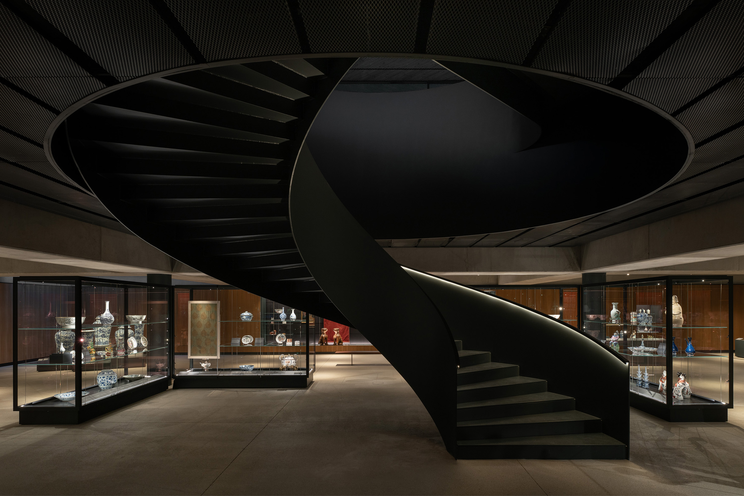 A spiral staircase leads down to the wood-lined gallery space, where a selection of 250 objects is currently on view in a long-term display called Connections: Works from the Albuquerque Collection