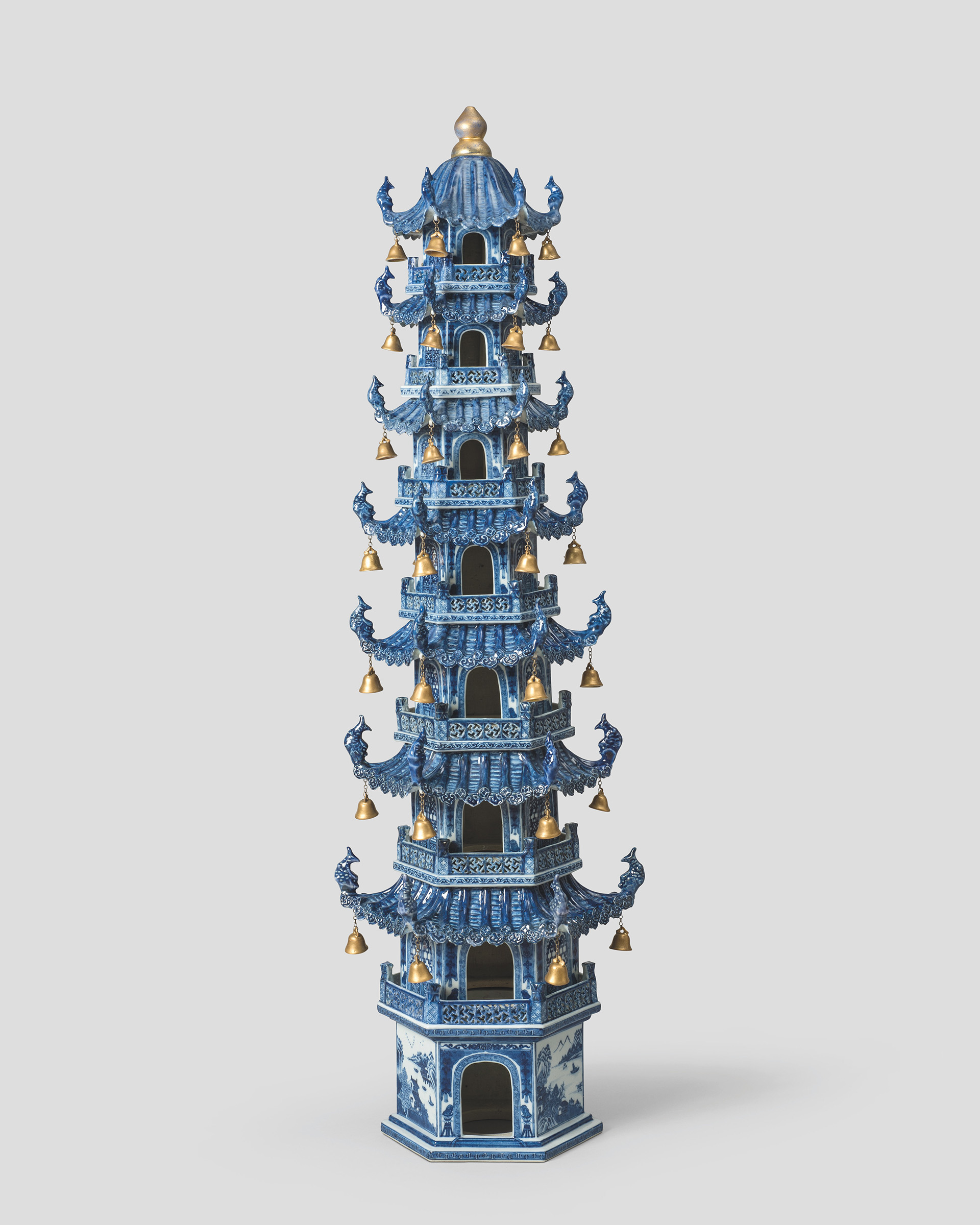 A Qing dynasty porcelain model of a pagoda, decorated in underglaze cobalt blue, with gold bells. Jingdezhen kilns, Jiangxi province, Jiajing period, late 18th to early 19th century