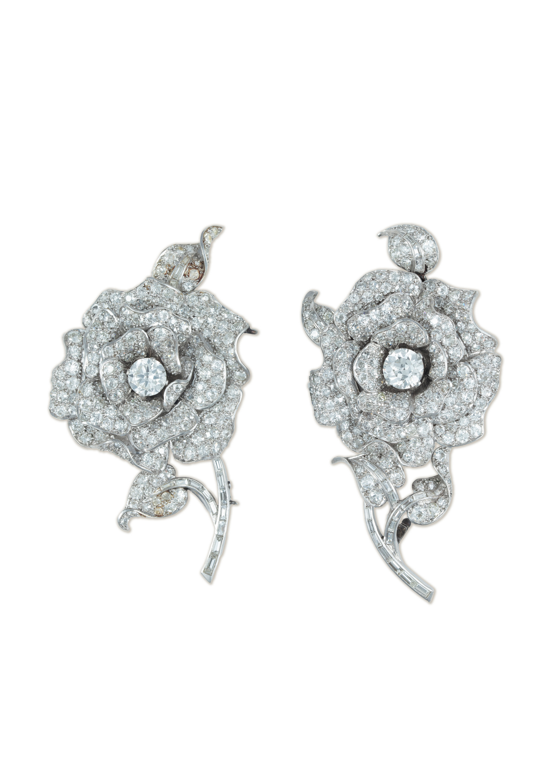 A diamond triple clip brooch, 1935. Designed as a pair of wild roses, each set throughout with round-, baguette- and cushion-shaped diamonds, offered by Christie's Private Sales