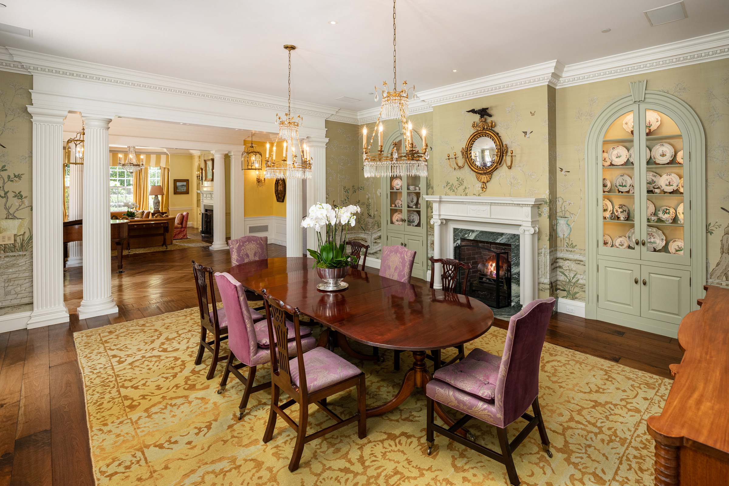The dining room has de Gournay wallpaper and a mirror adorned with an eagle, a motif that also appears on wall sconces elsewhere in the house. The property is available via Christie's International Real Estate