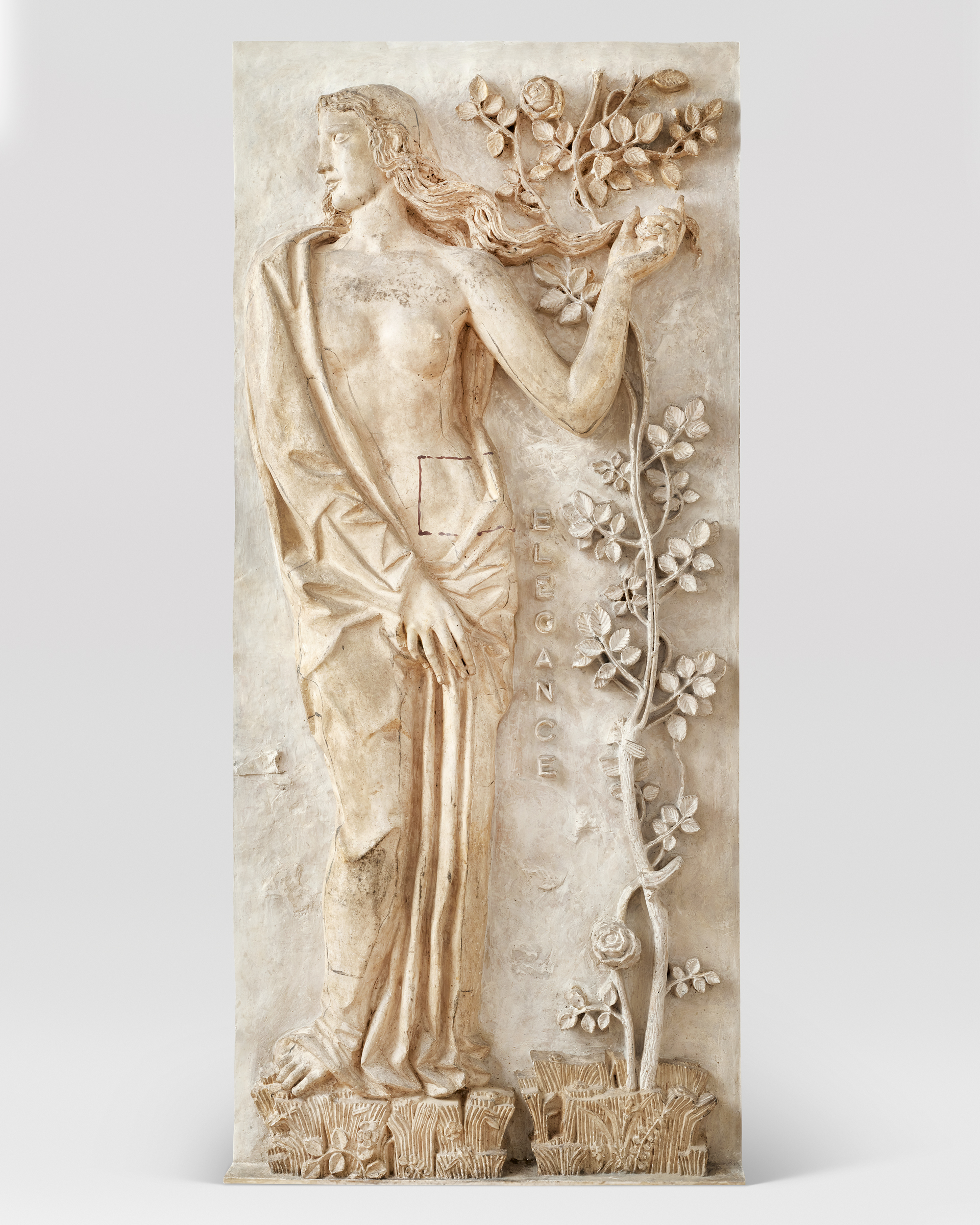 A relief sculpture depicts a partially draped figure holding a branch, standing next to a flowering plant with the word "ELEGANCE" engraved vertically.