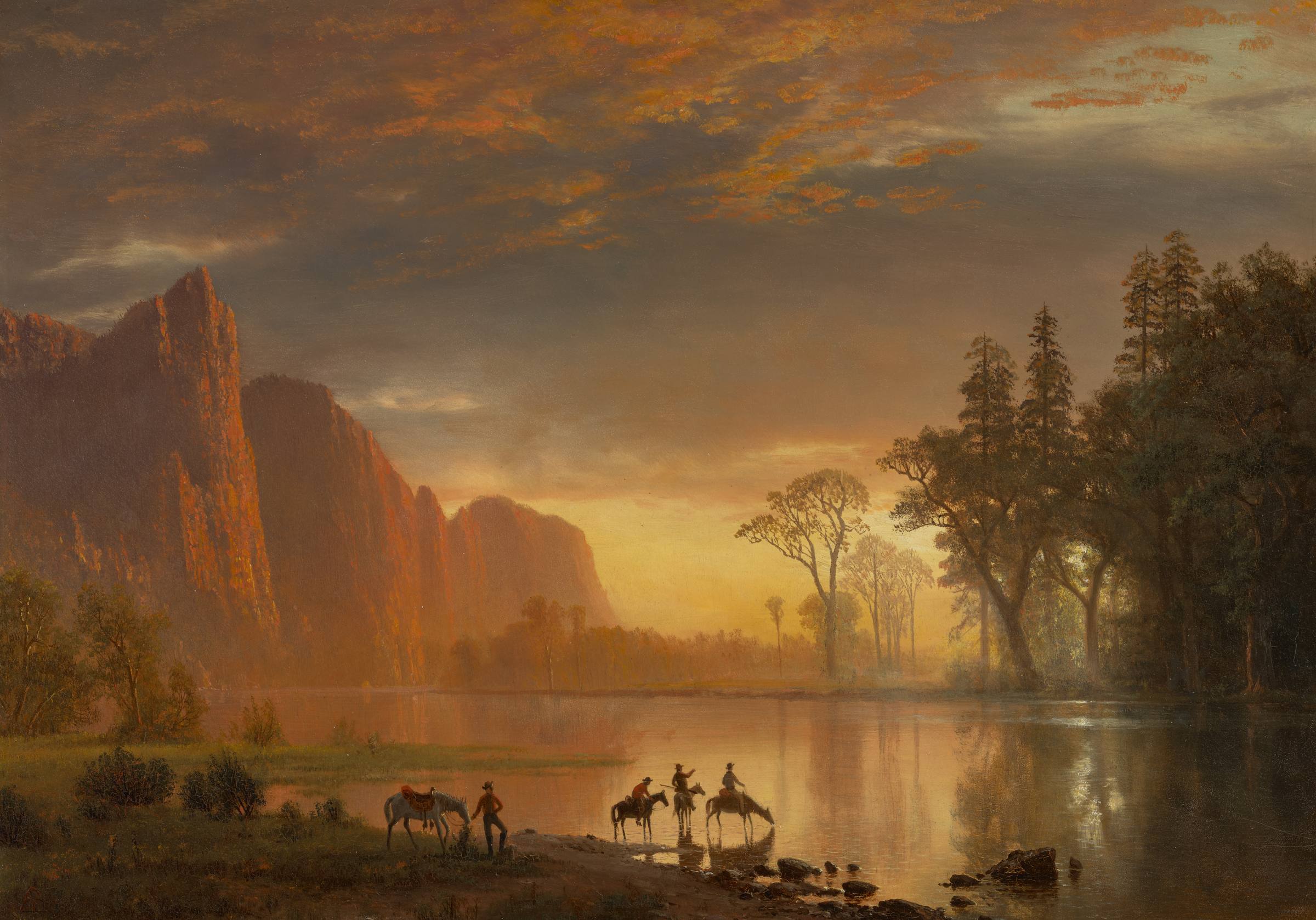 Three riders and horses by a calm river at sunset, with cliffs and tall trees in the background.