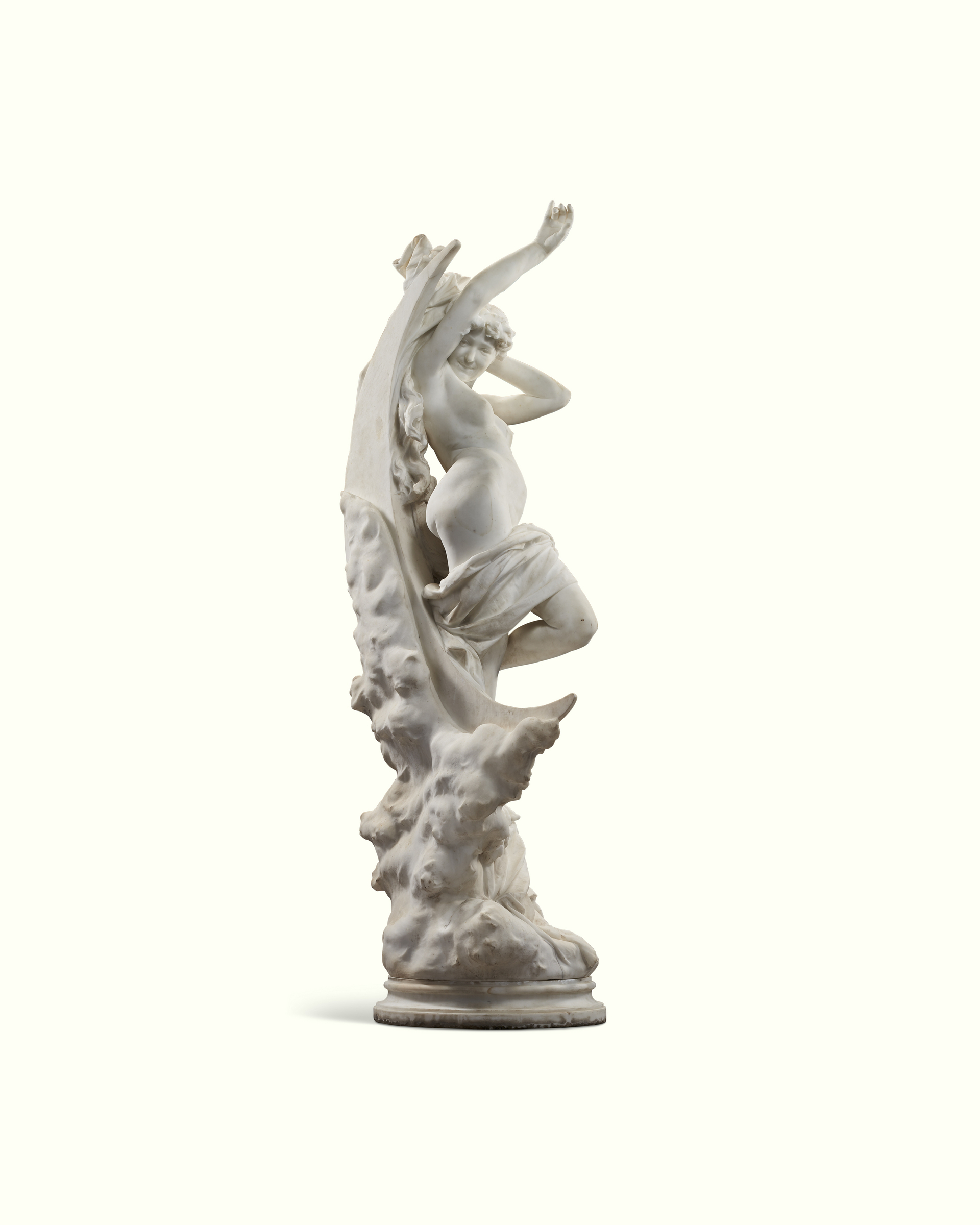 A white marble statue depicts a graceful, partially draped female figure with raised arms.