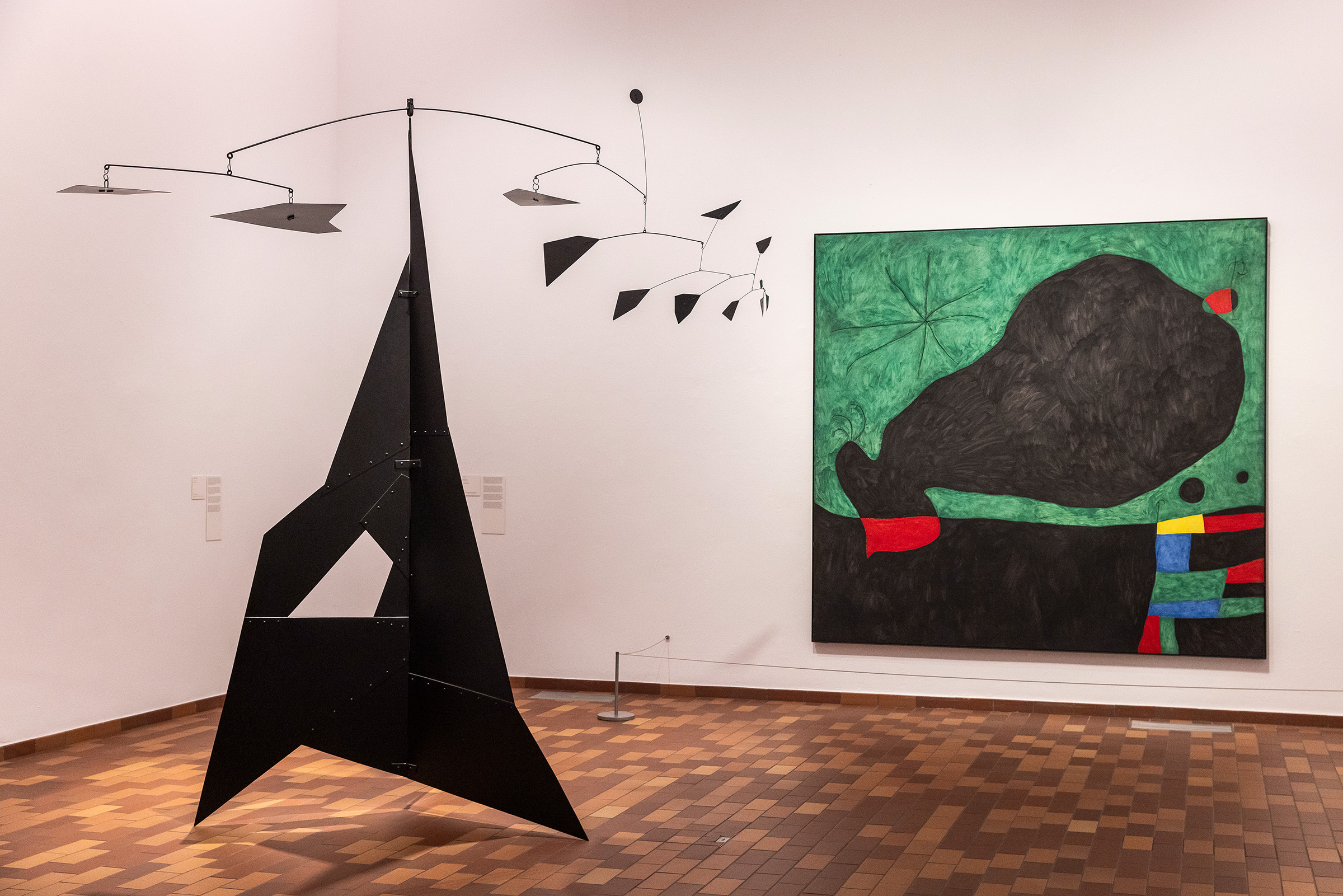 Installation view of Miro and the United States, on show at the Fundacio Joan Miro until 22 February 2026. Alexander Calder's sculpture El Corcovado (The Corcovado), 1951, appears alongside Miro's Message d'ami (Message from a Friend), 1964