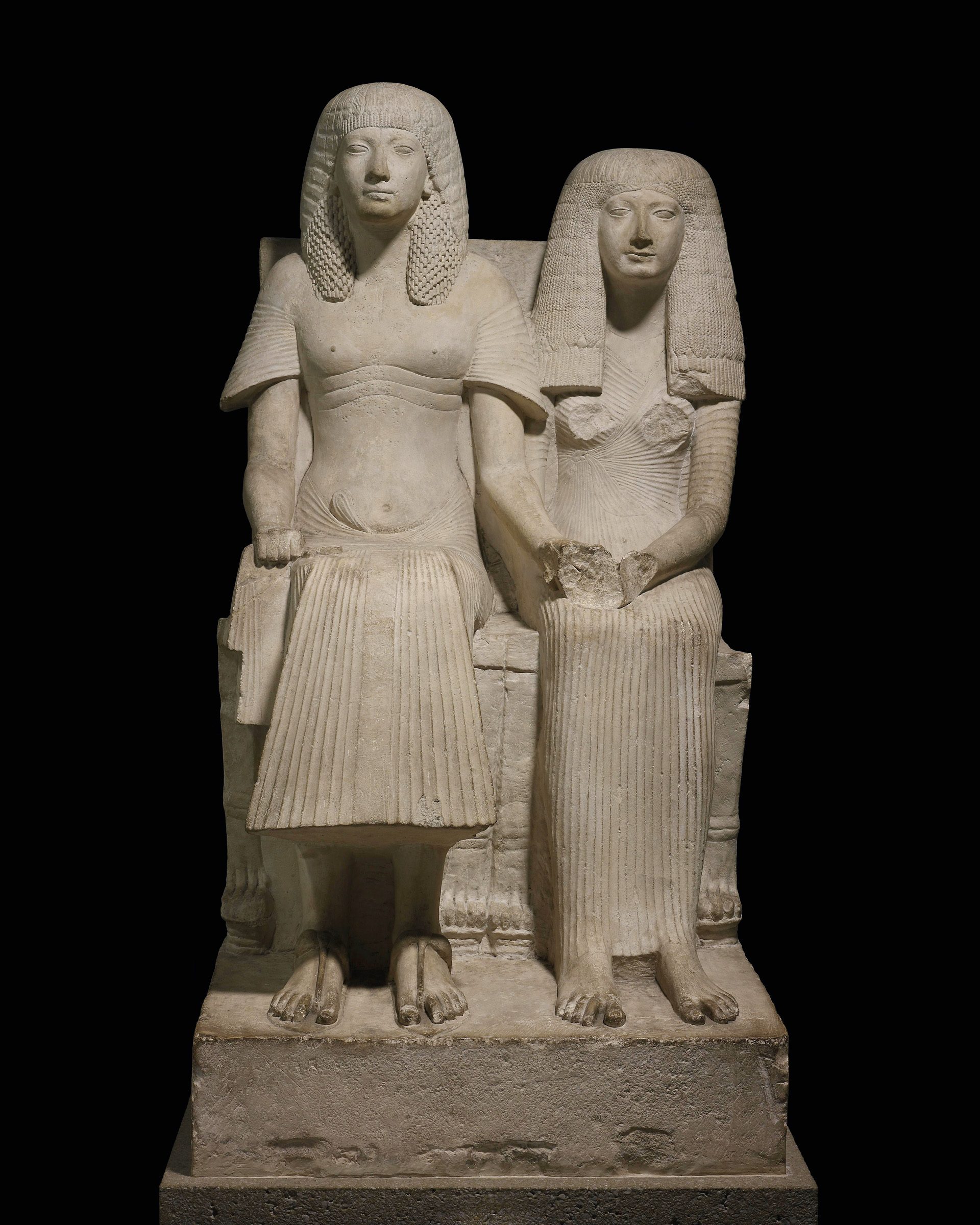 The British Museum's limestone statue of the pharaoh Horemheb and one of his wives, seated on chairs with lion's-paw feet, circa 1300-1250 B.C., late 18th or early 19th dynasty