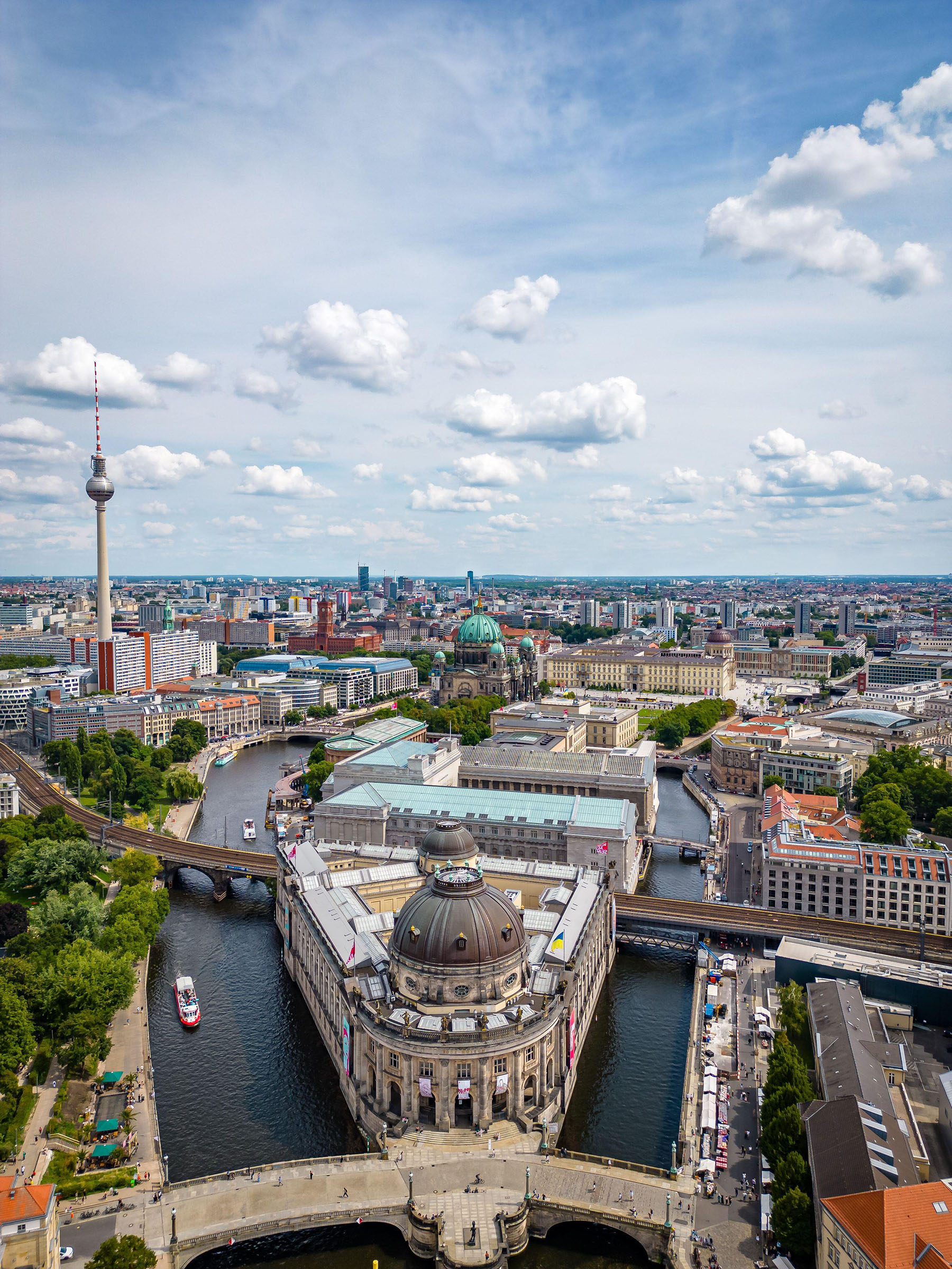 A view of Berlin's Museum Island, stretching from the Bode Museum at its northernmost point to the Humboldt Forum at the far end, lying to the right of the clustered domes of Berlin Cathedral