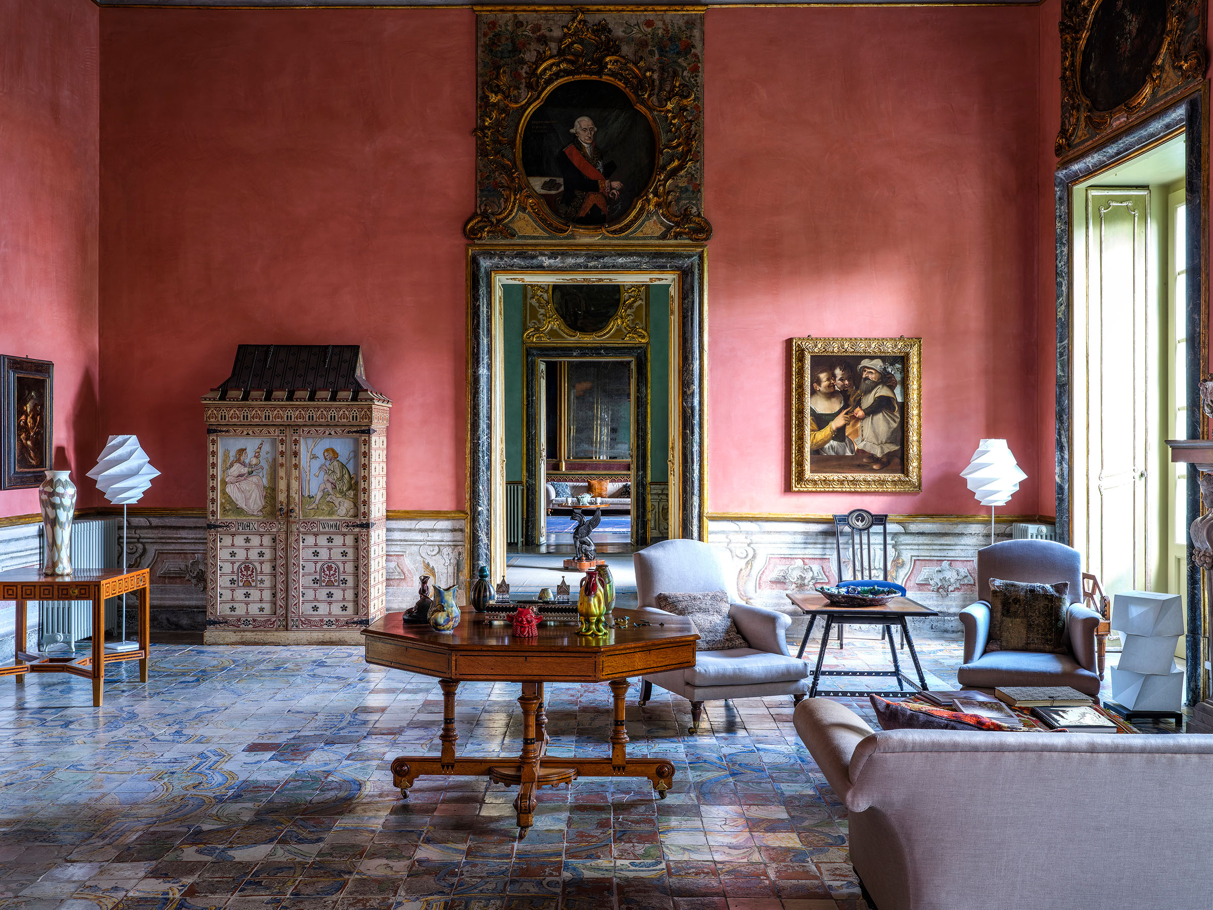 Among the art and objects in the Pink Room are an 1858 Arts and Crafts Flax and Wool cabinet designed by William Burges and painted by Frederick Smallfield, to the left of the doorway, and Annibale Carracci's Allegory with a Buffoon, 1585, to the right