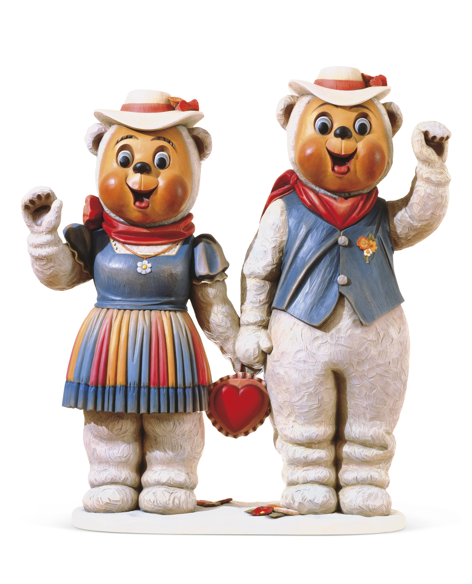 Two bear figurines dressed in colorful Western outfits hold a red heart together.