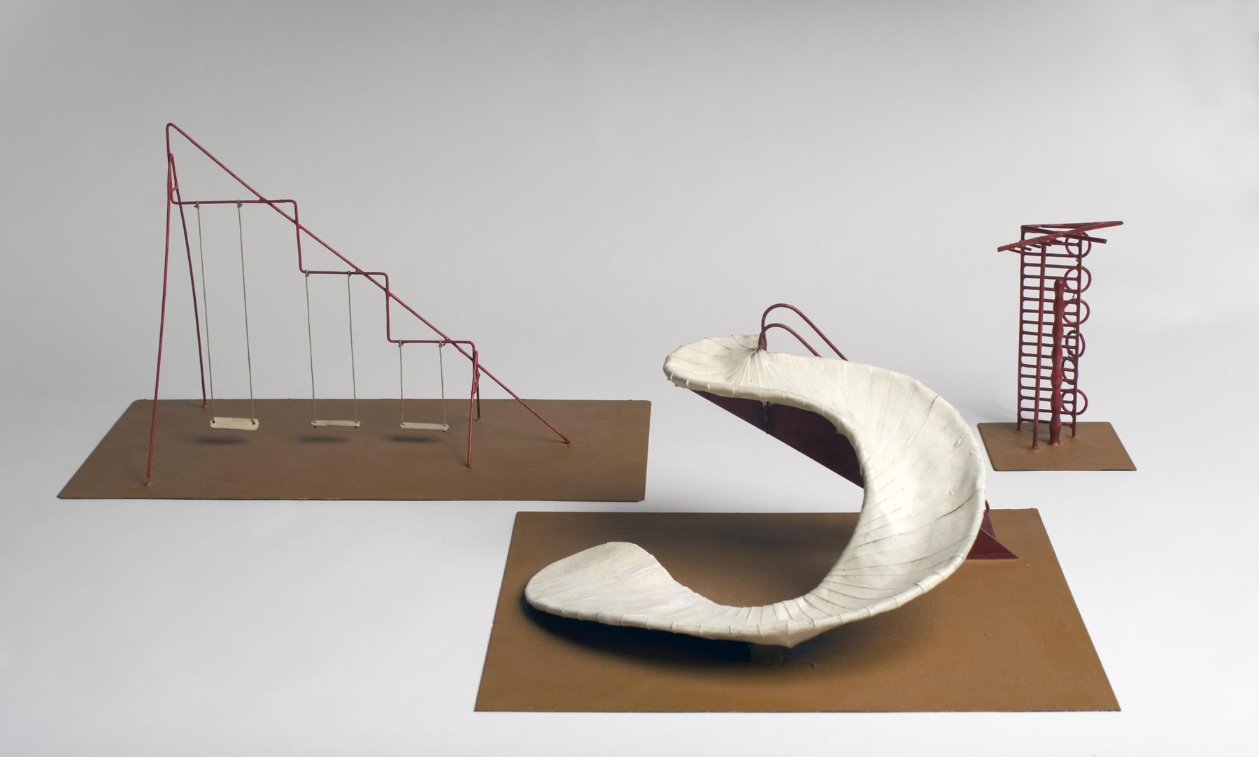 A model playground set with swings, a spiral slide, and a tall climbing structure is shown.