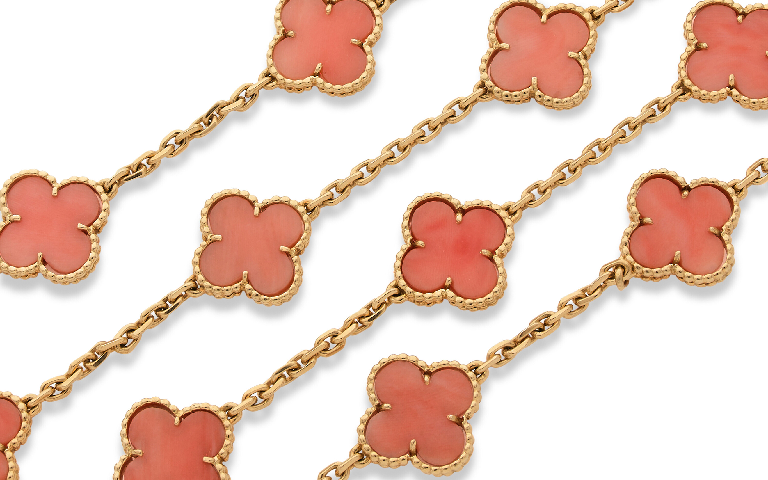 Gold chains with pink clover-shaped charms arranged in a diagonal pattern.