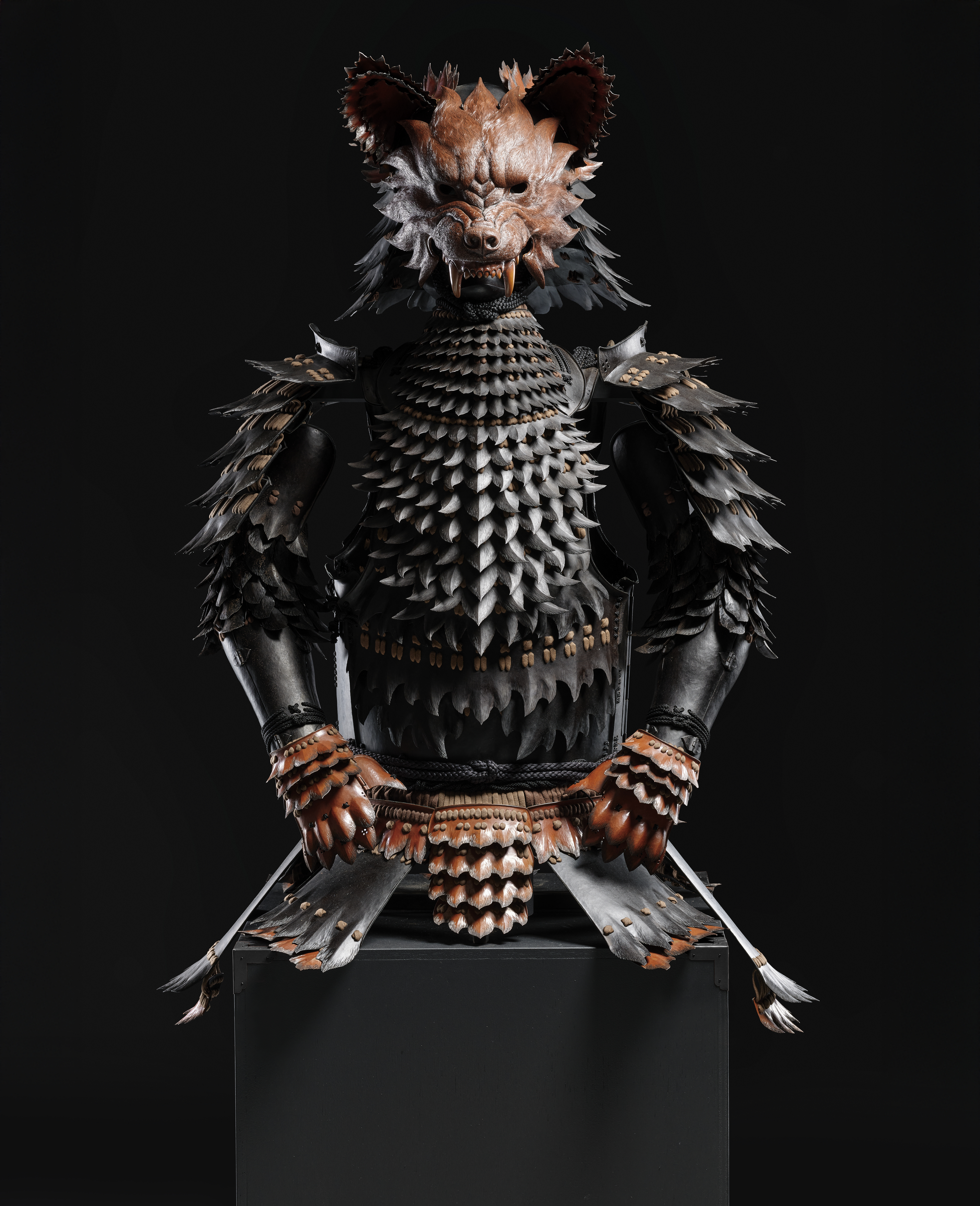 A suit of armor with a fierce wolf-like mask and layered, scale-like design.