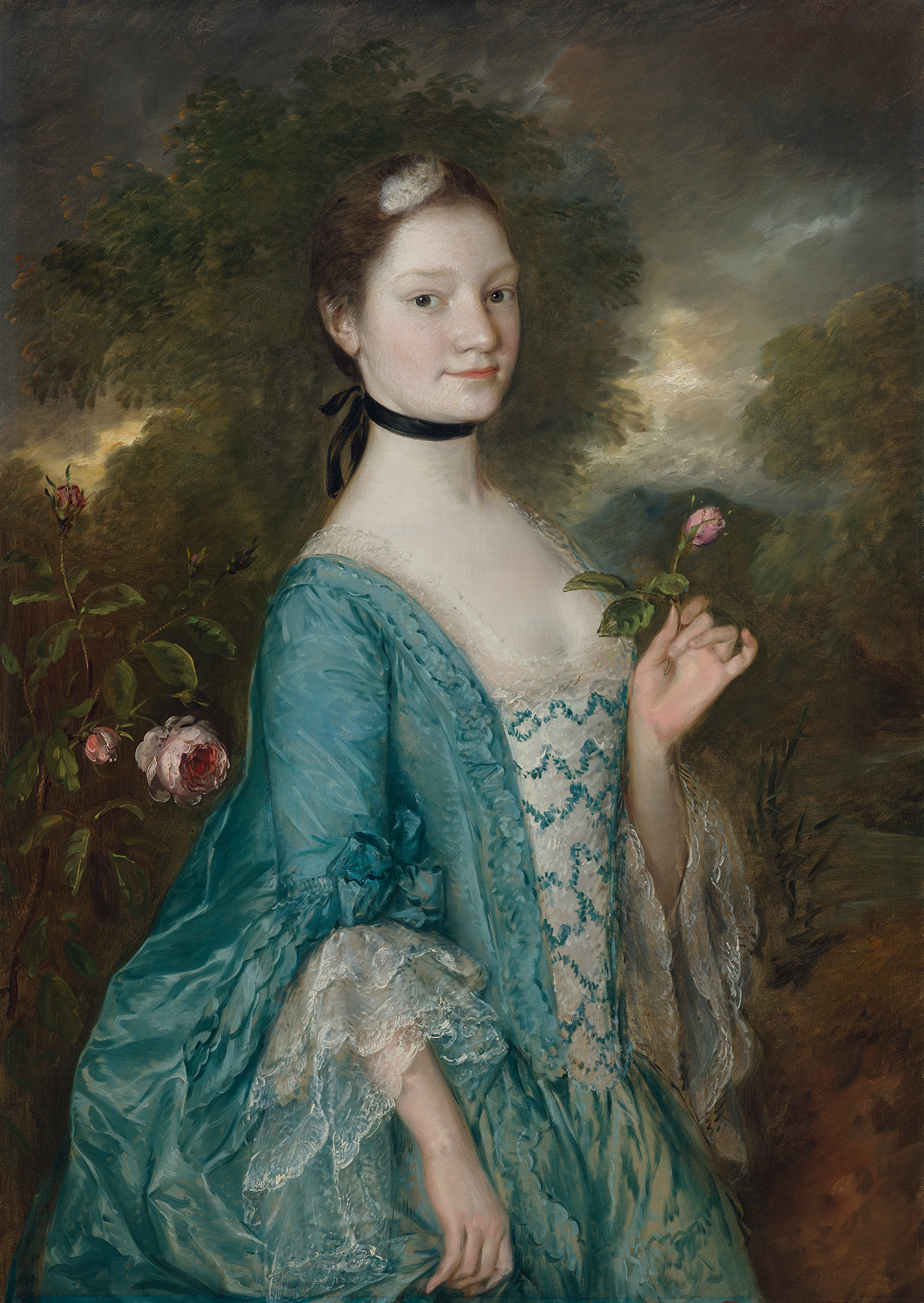 A woman in a blue 18th-century dress holds a pink rose, standing in a lush garden.