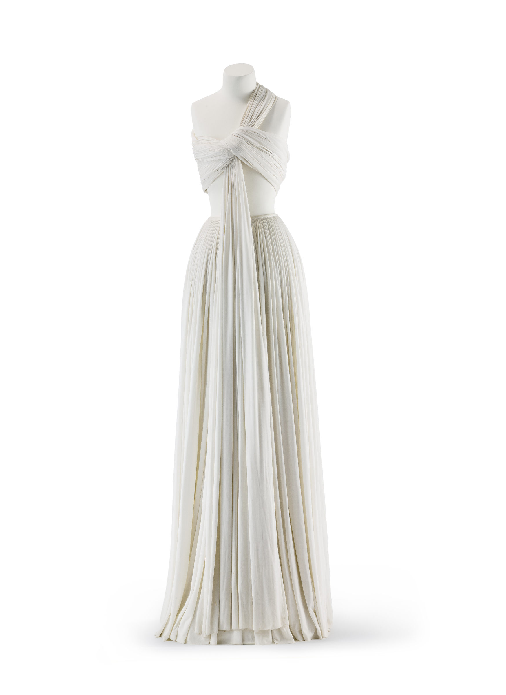 A long, flowing white dress with a draped and wrapped bodice on a mannequin.