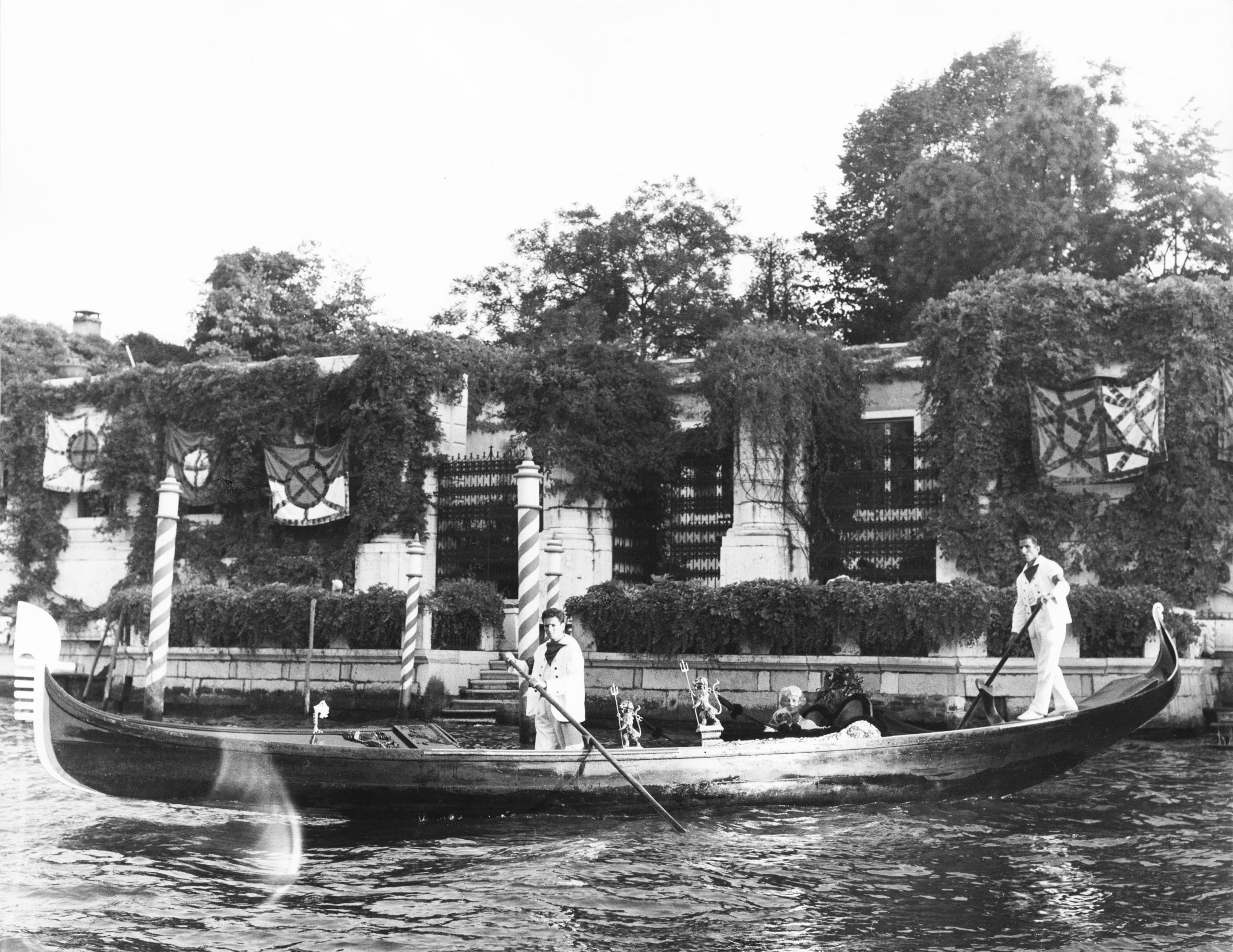Peggy Guggenheim in her gondola in front of Palazzo Venier dei Leoni, Venice, circa 1965