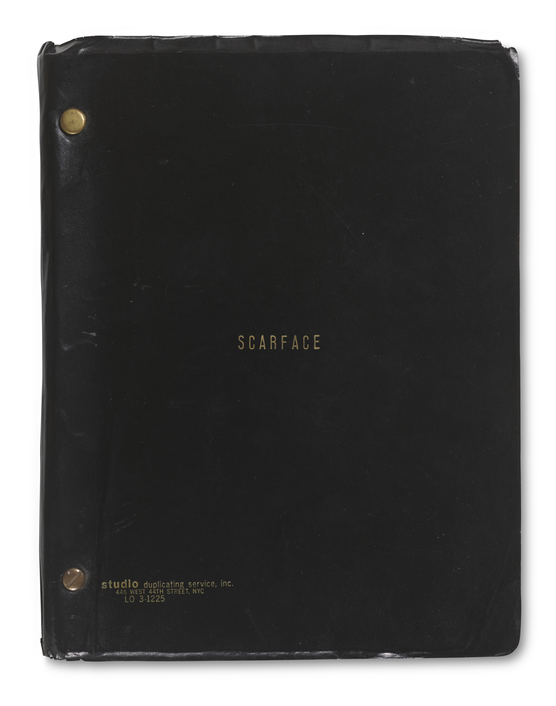A black binder with the word "SCARFACE" in gold letters on the cover.
