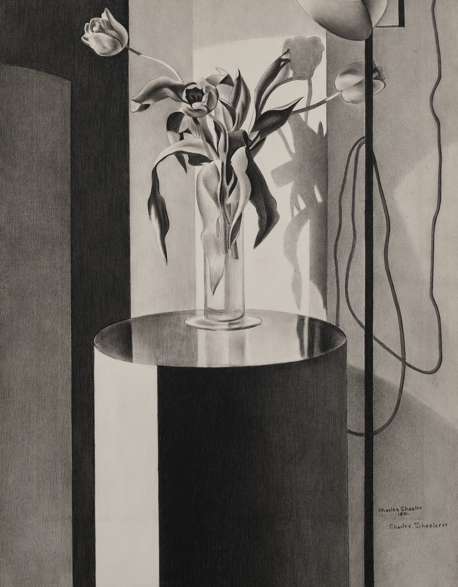 A glass vase with tulips sits on a reflective round table, casting distinct shadows on the wall.