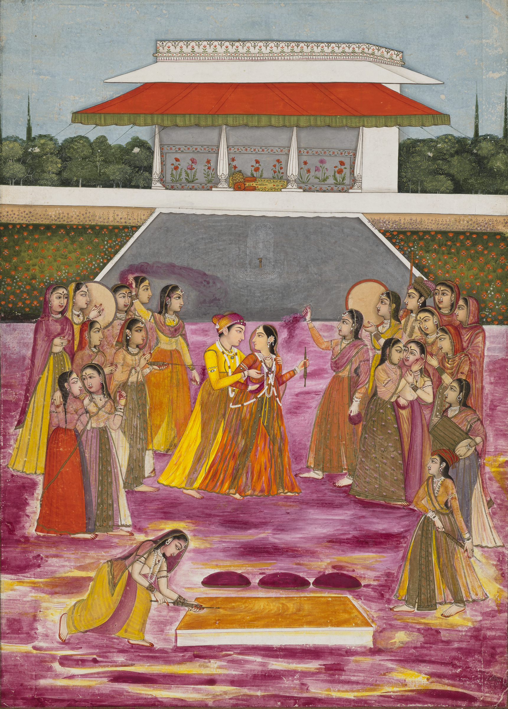 A group of women in colorful traditional attire gather near a palace and a platform in a garden.