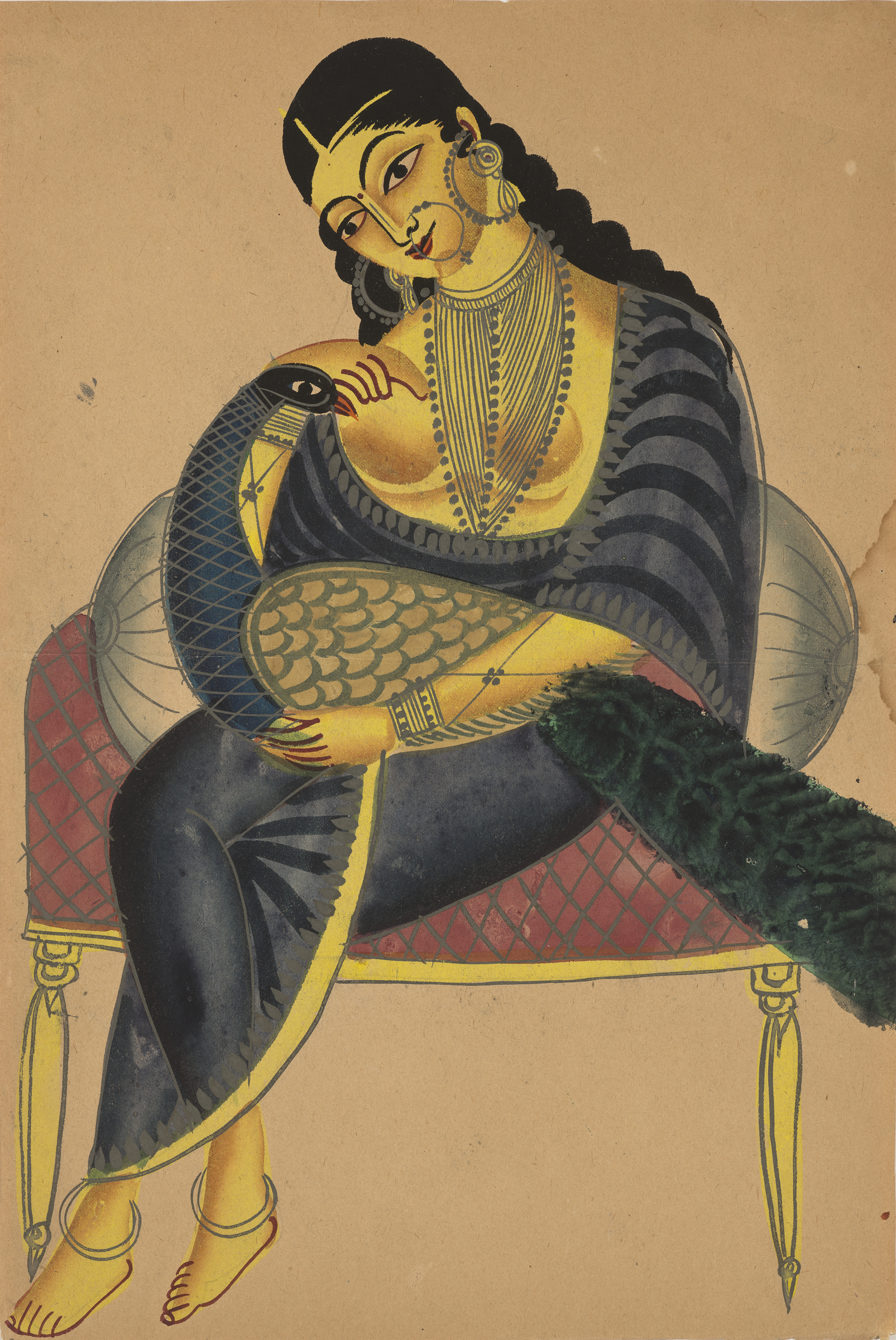 A woman in traditional attire sits on a chair holding a peacock, adorned with jewelry.