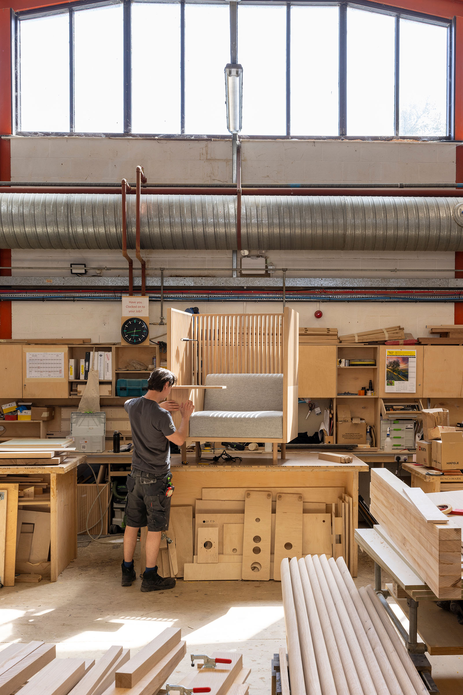 One of Benchmark's artisans working on a chair upholstered with organic, sustainable wool, which is also naturally fire-retardant. 'As a furniture-maker, you inherently care about sustainability, because of a reverence for the materials that you’re working with', says Martin Penrose