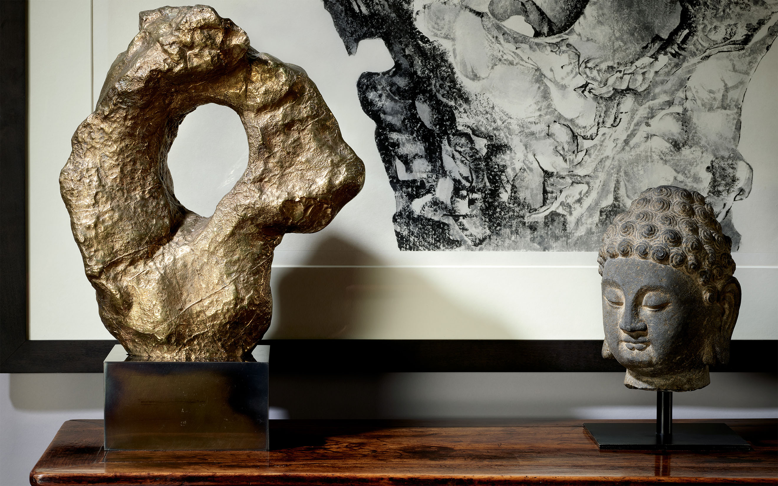 From left: Clive Barker, Rock. Liu Dan, Auspicious Cloud, 2012. Scroll, mounted, framed and glazed, ink on paper. A grey limestone head of Buddha, China, Tang dynasty. All offered in The Flacks Family Collection II: Curtain Call on 12 May 2026 at Christie's in London