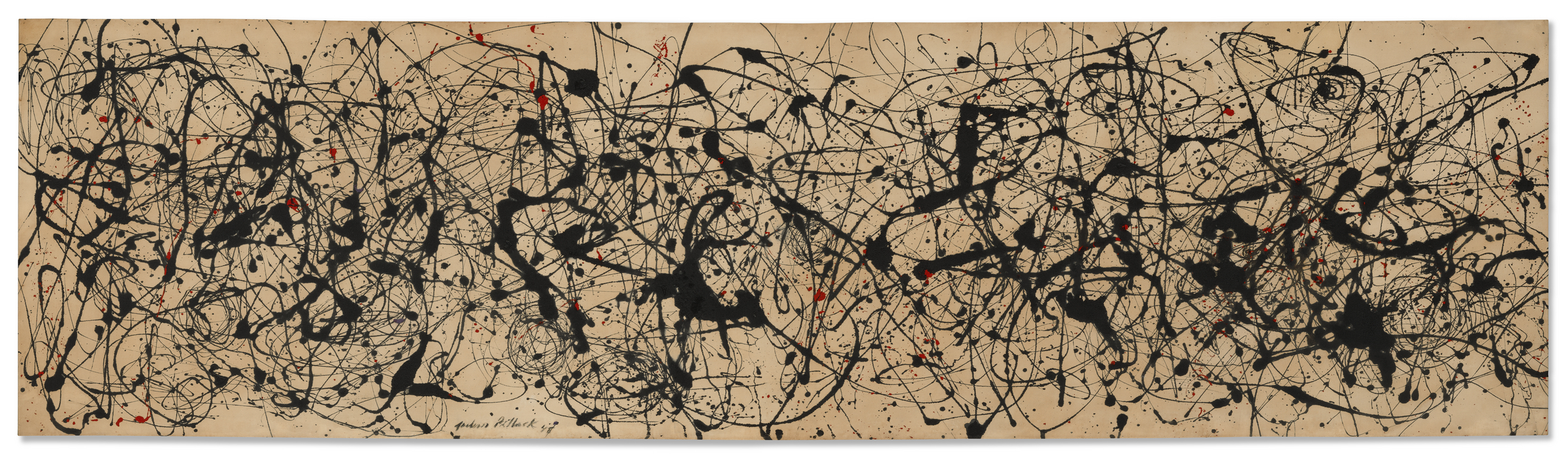 Black, red, and white paint splatters and drips cover a large beige canvas in an abstract pattern.