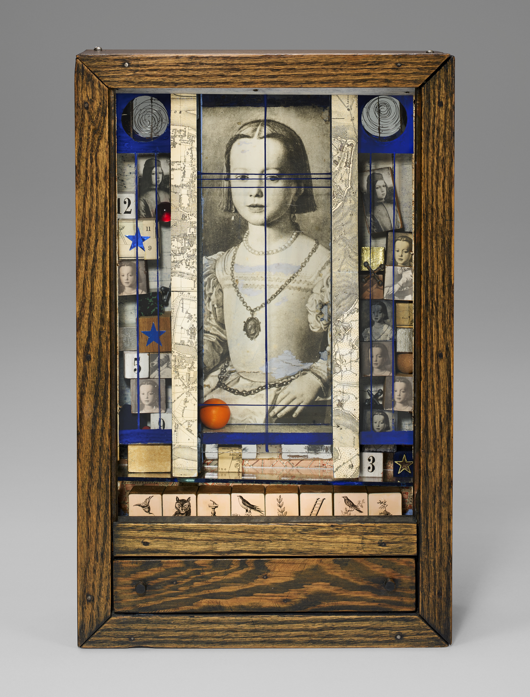 A wooden-framed mixed media collage features a vintage portrait with objects and symbols arranged inside.