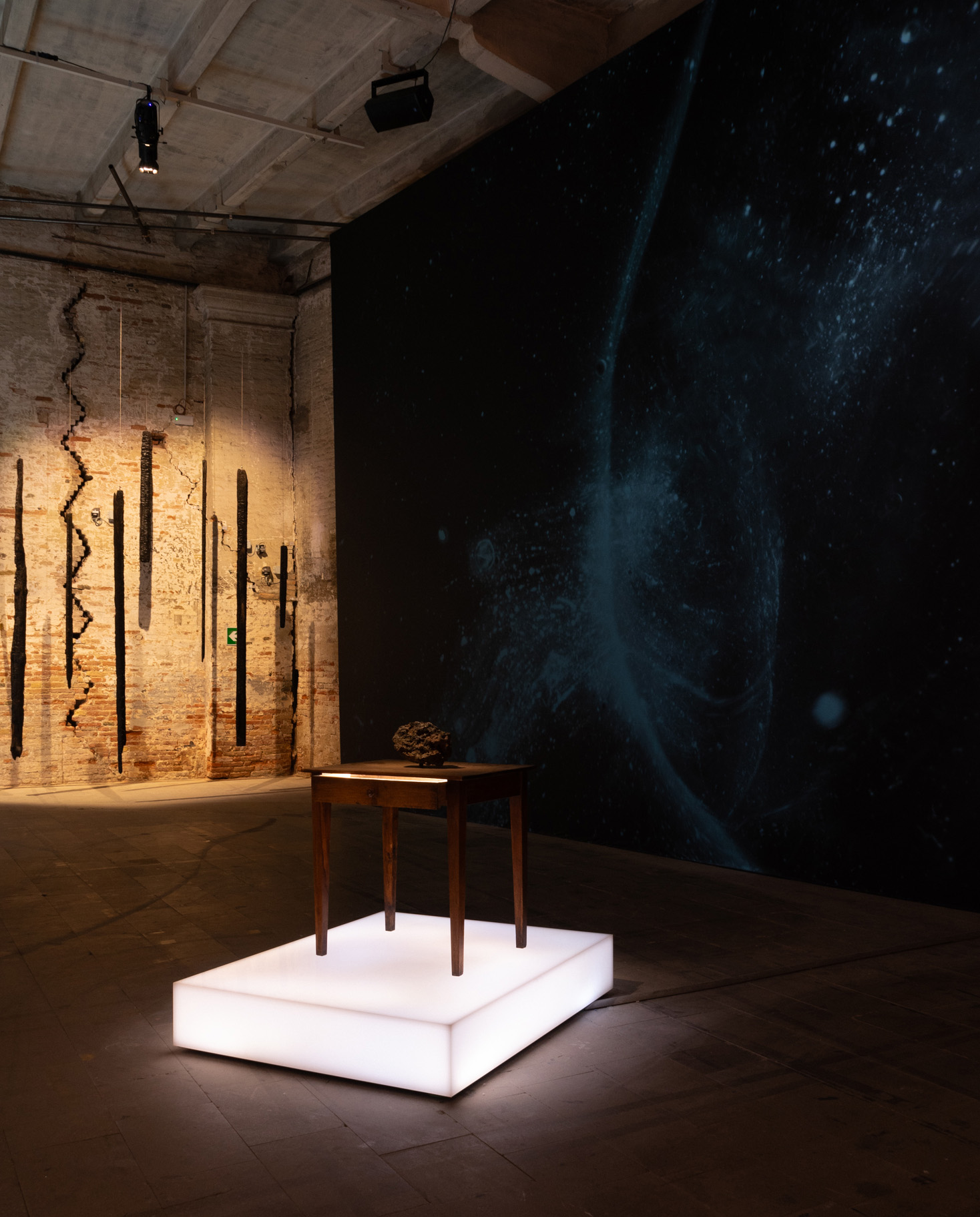 Installation view of the Venice Biennale's 61st International Art Exhibition, In Minor Keys, including, clockwise from back: Dawn DeDeaux, Burnt Chimes: In Minor Keys for Koyo Kouoh, 2006/2026; Meteor in Motion, 2021/2026, digital projection; and Meteor Study Desk, 2024-26