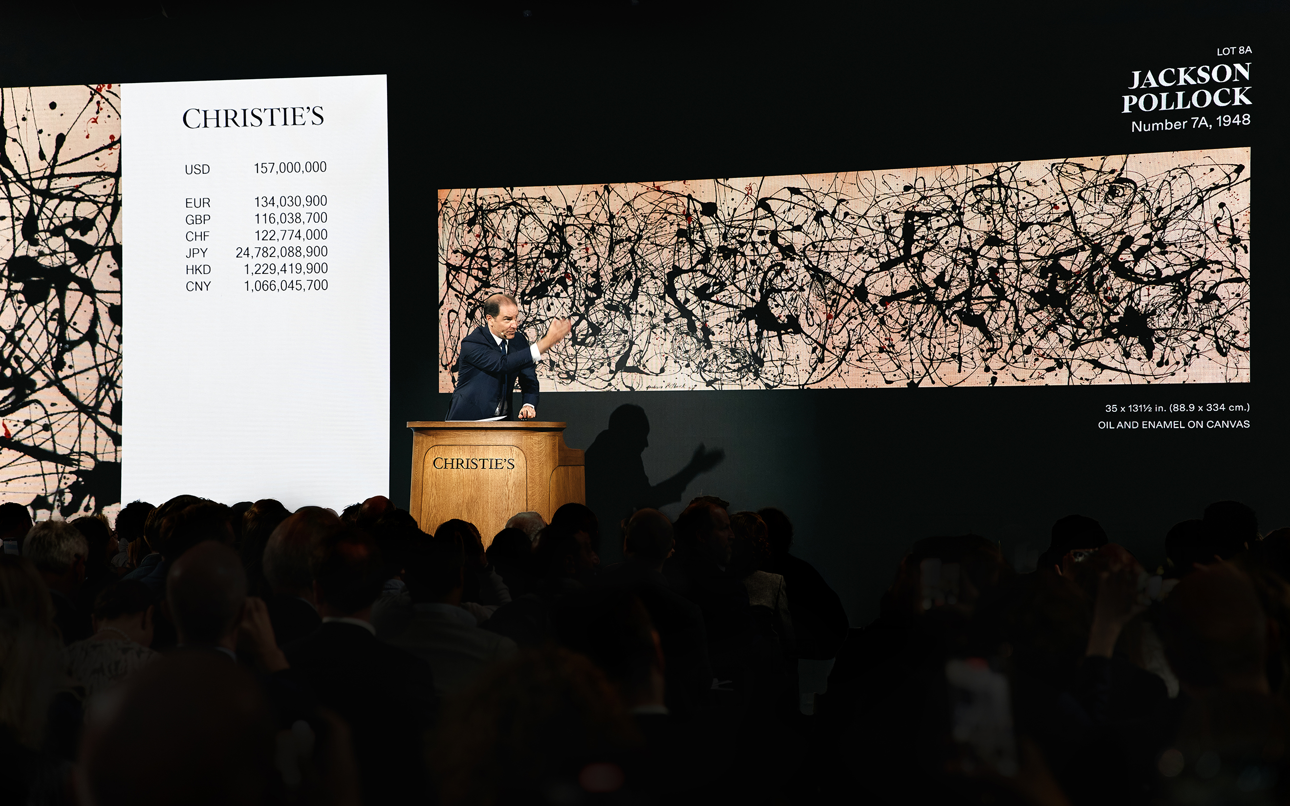 An auctioneer presents Jackson Pollock's "Number 7A, 1948" at a Christie's art auction.