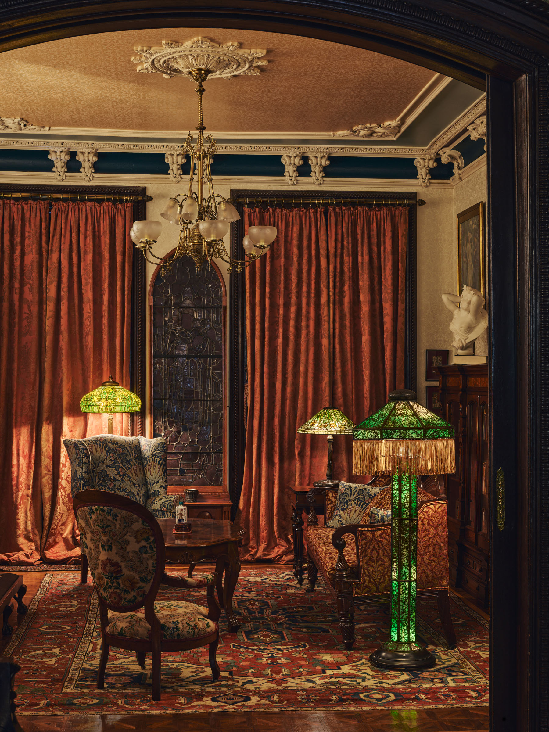 A sitting room in Zuckerman's house in Chelsea, illuminated with lamps from his collection of works by Tiffany Studios and Revere Studios, which was sold at Christie's in New York in December 2025