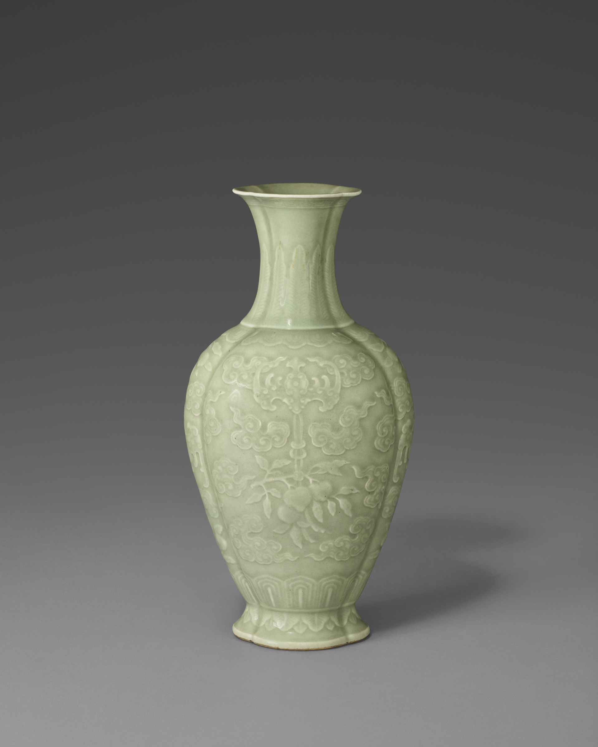 A pale green ceramic vase with floral and cloud motifs and a flared neck.