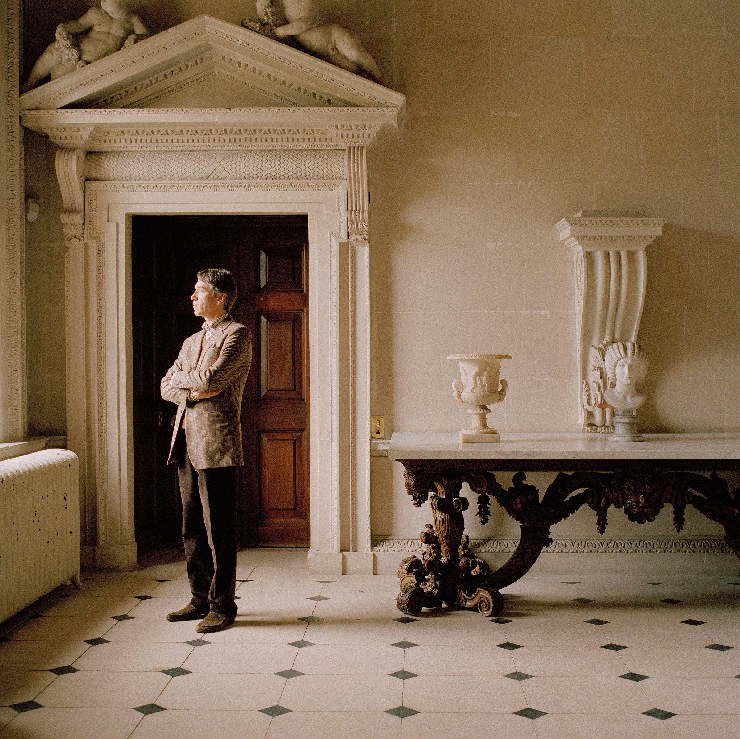 The Marquess of Cholmondeley in the Stone Hall, a grand, double-height room that serves as a transitional space between Houghton's outdoor and indoor areas