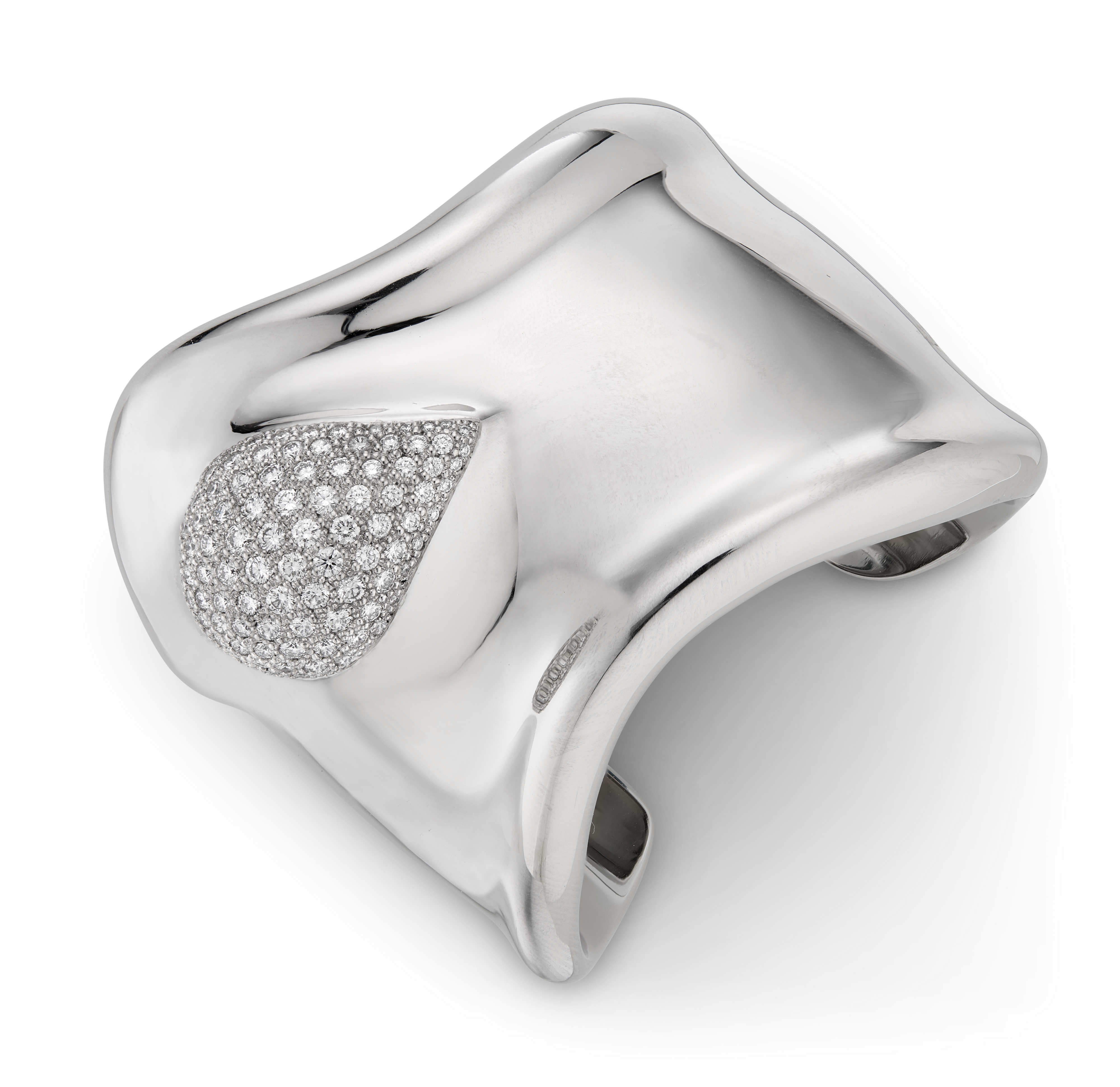 A wide, shiny silver cuff bracelet with a teardrop shape encrusted with small diamonds.