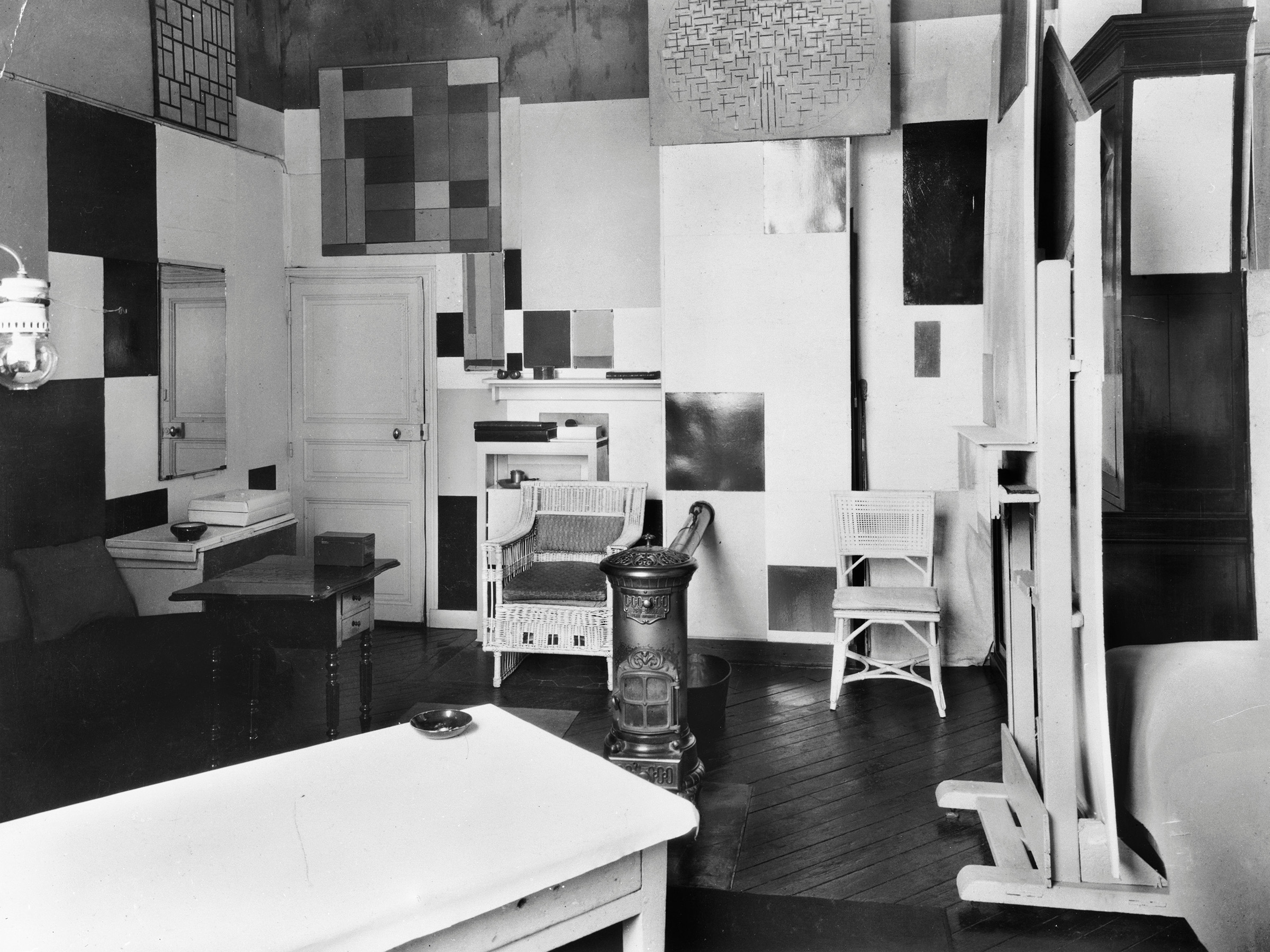 Mondrian's Paris studio, 26 Rue du Depart, in 1925-26. The paintings on the walls show the evolution of his work