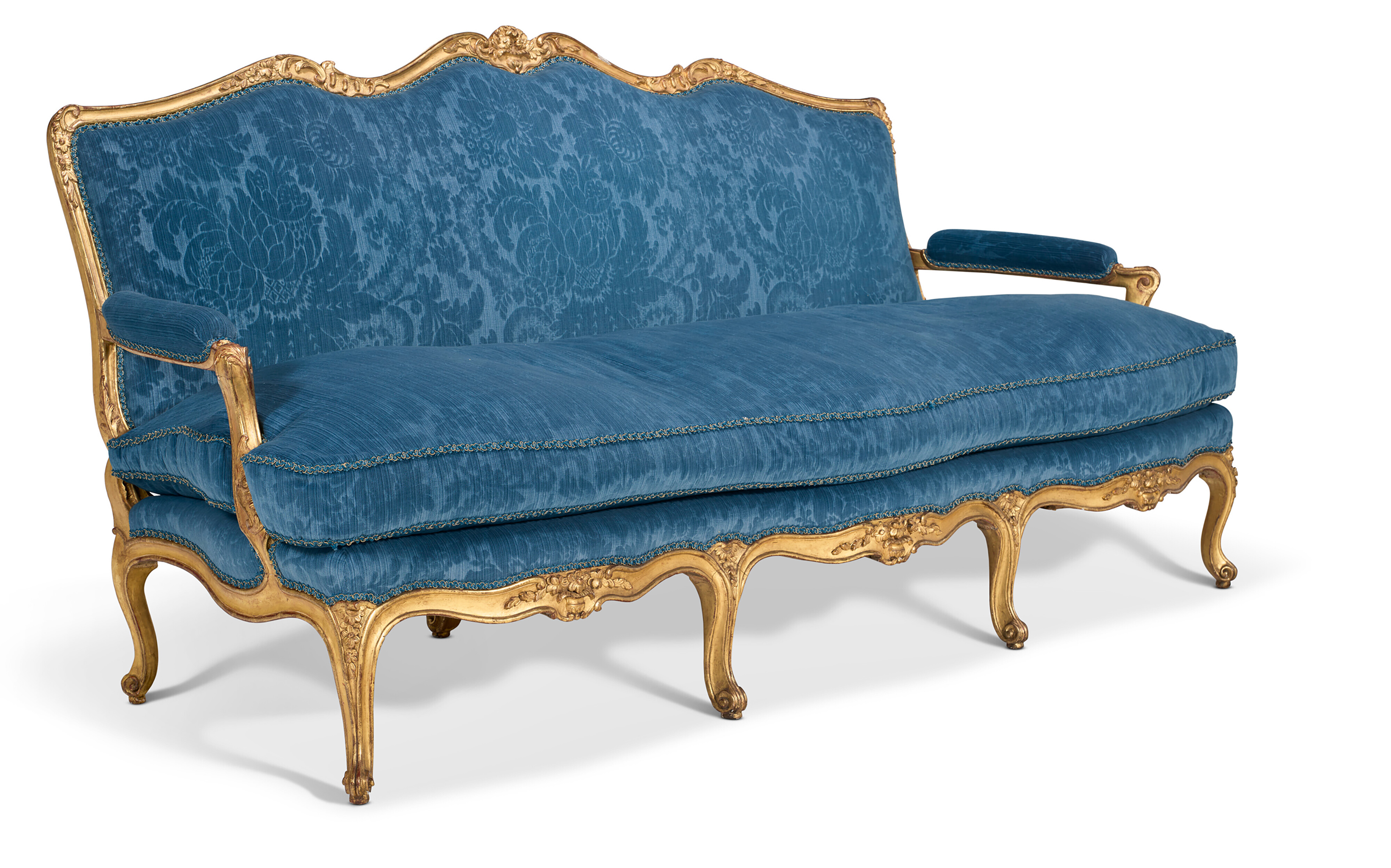 An ornate blue upholstered sofa with gold carved wooden frame and floral patterns.