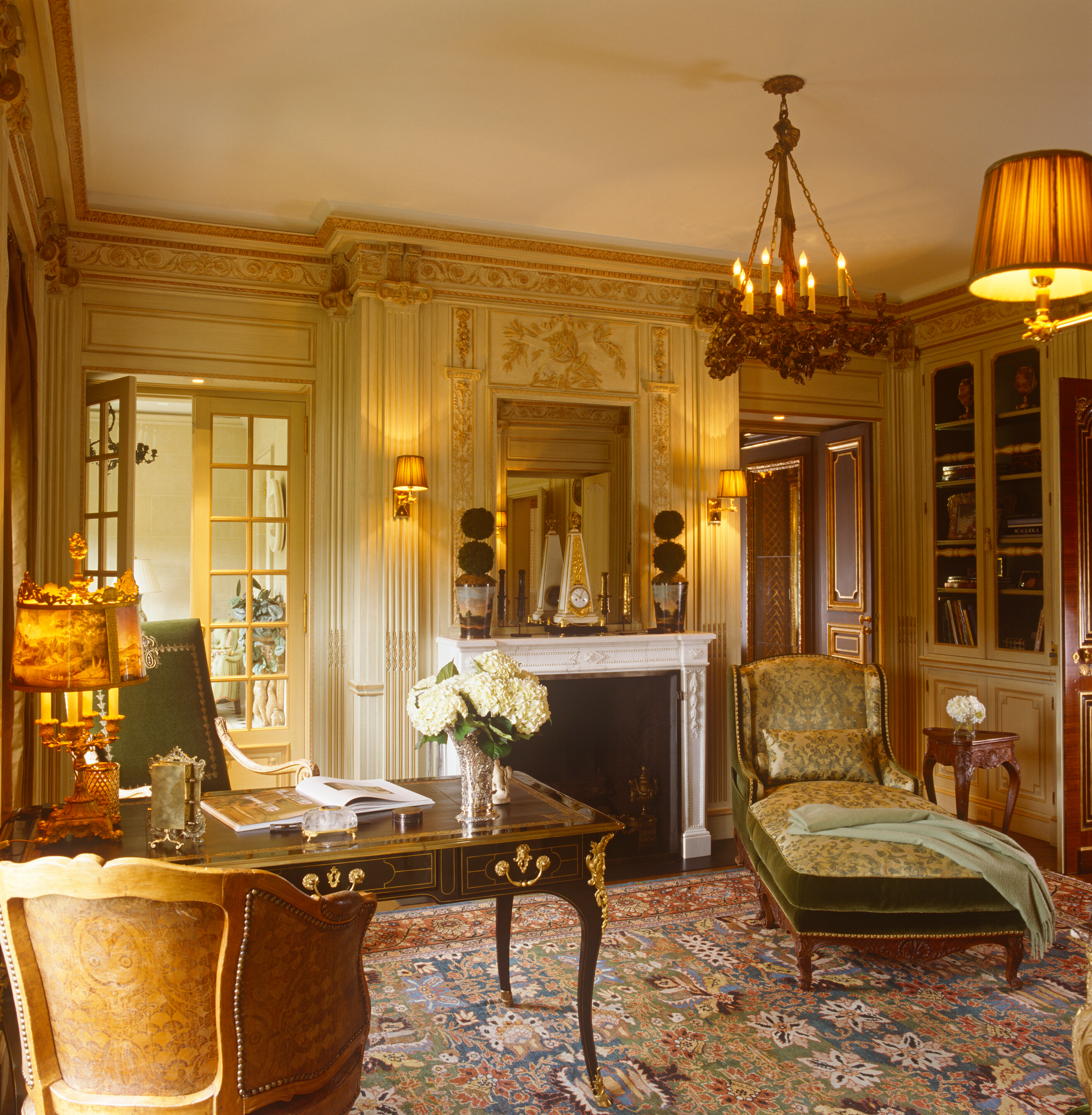 A luxurious vintage-style living room with ornate furniture, a fireplace, and elegant decor.