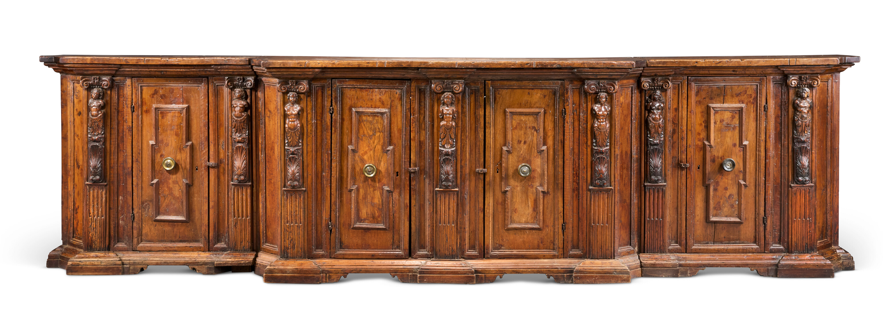 A large antique wooden sideboard with detailed carvings and multiple paneled doors.