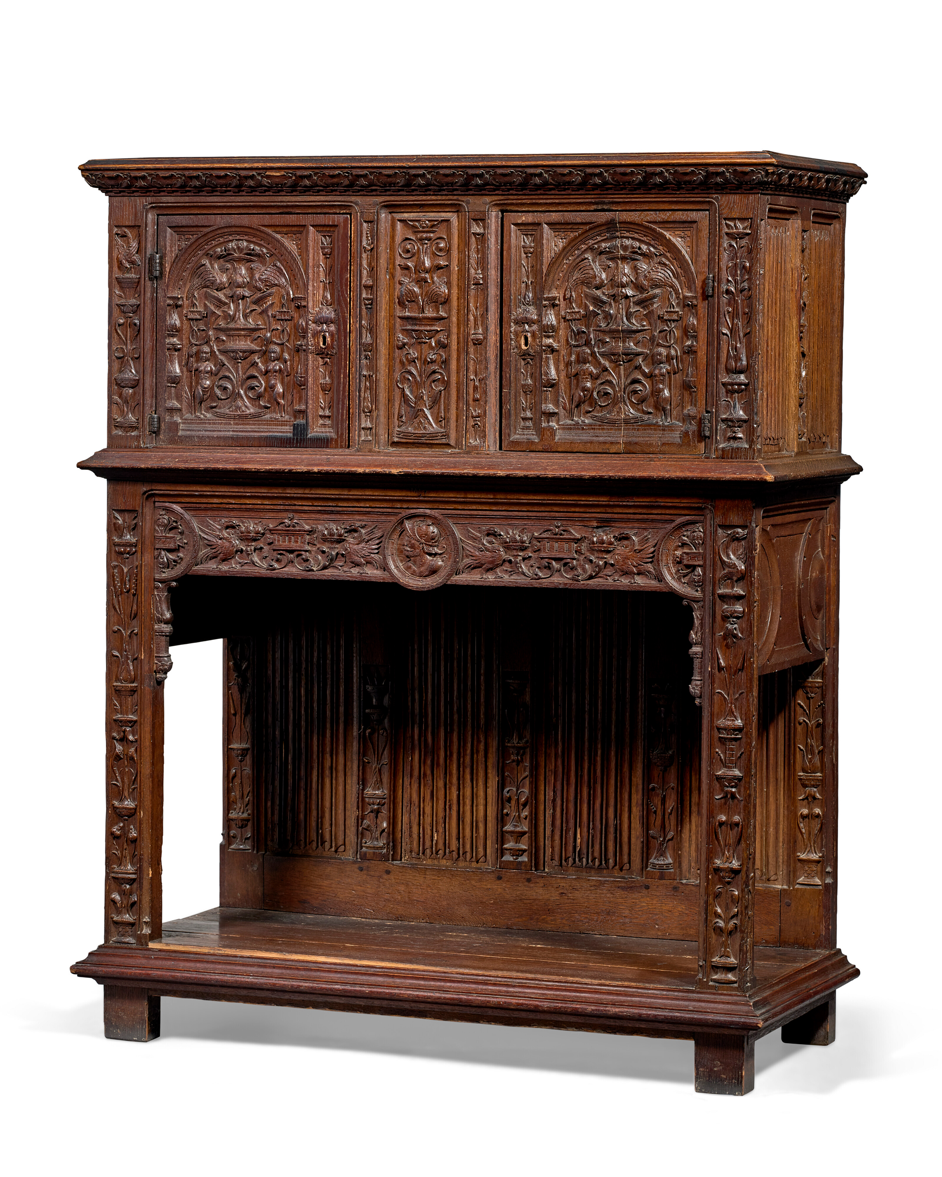 An antique wooden cabinet with intricate carvings and detailed decorative panels.