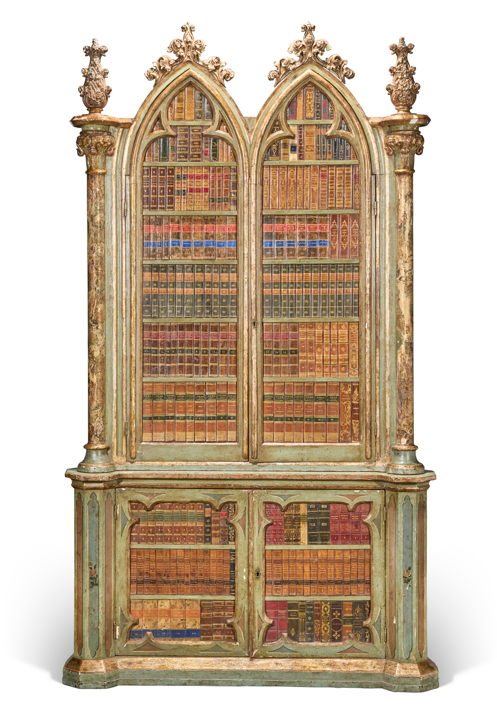 An ornate, vintage bookshelf with glass doors displays neatly arranged, colorful leather-bound books.