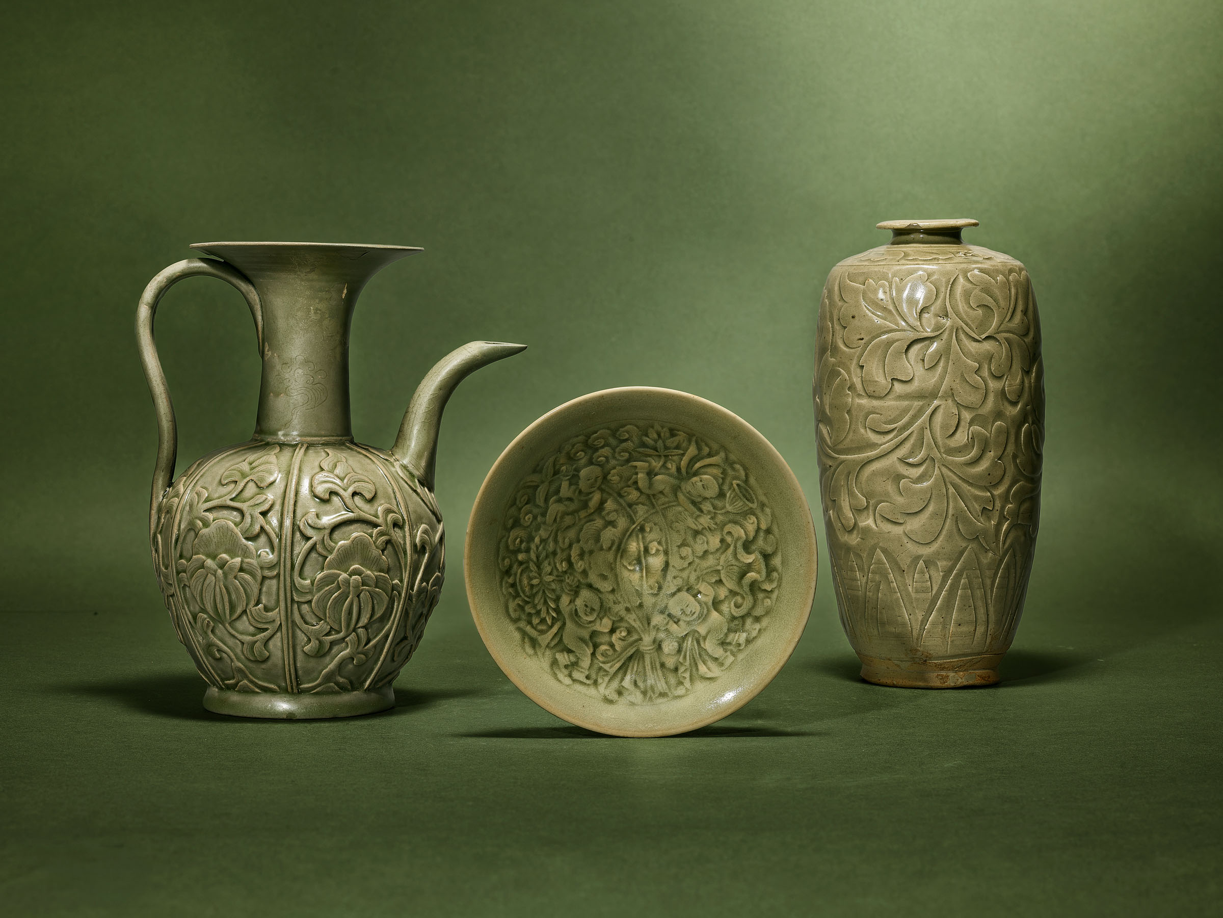 From left: a rare Yue celadon carved and moulded Peony ewer, China, Northern Song dynasty (960-1127); a Yaozhou celadon moulded Boys bowl, China, Northern Song-Jin dynasty (960-1234); a Yaozhou celadon carved Peony vase, meiping, China, Jin dynasty (1115-1234). All offered in Fine Asian Art on 6 November 2026 at Christie's in London