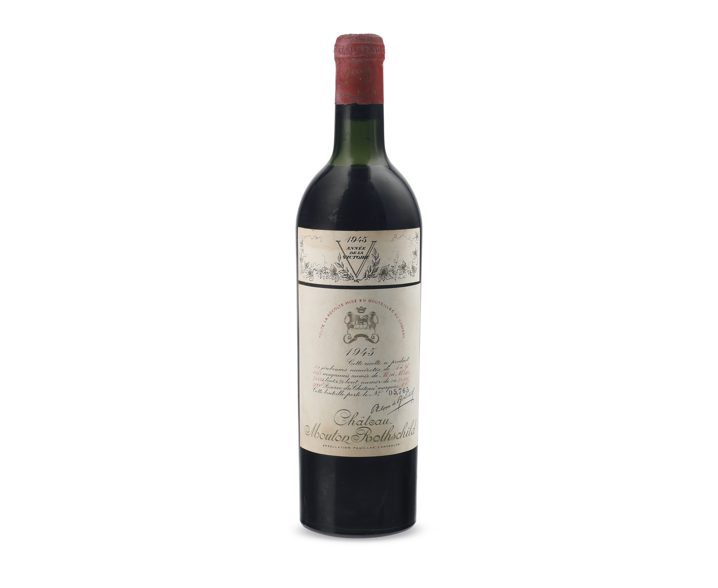 A bottle of Château Mouton Rothschild red wine from the year 1945 with a vintage label.