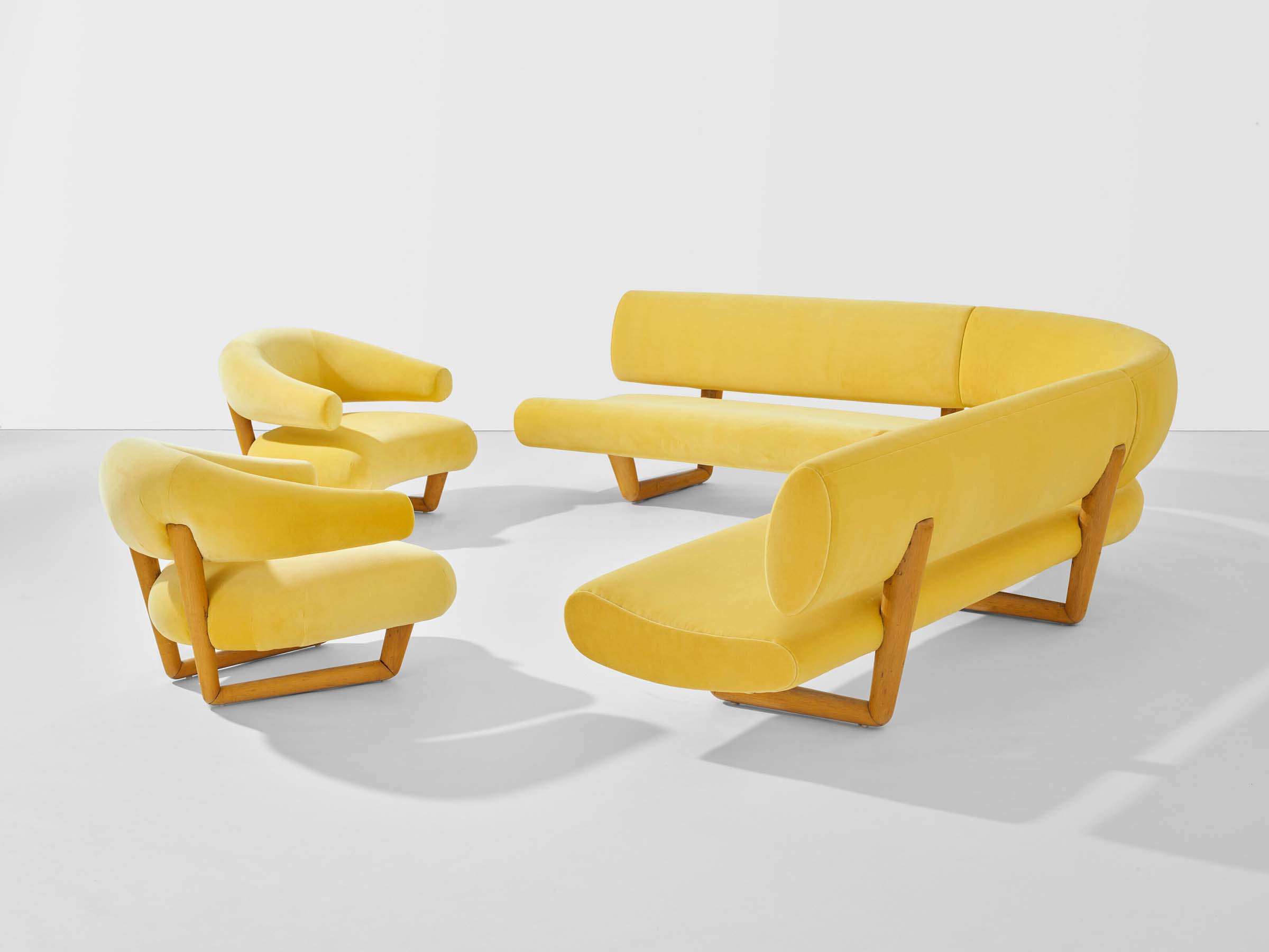 Jean Royère (1902-1981), Pair of 'Sculpture' Armchairs, circa 1955. Oak, velvet upholstery. 27¾ x 28¾ x 32⅞ in (70.5 x 73 x 83.5 cm). Estimate: $300,000-500,000; Jean Royère (1902-1981), Rare ‘Sculpture’ Sofa, c. 1955. Oak, velvet upholstery. 29 x 111 x 111 in (73.7 x 281.9 x 281.9 cm. Estimate: $300,000-500,000. Offered in Design on 8 June 2023 at Christie’s in New York