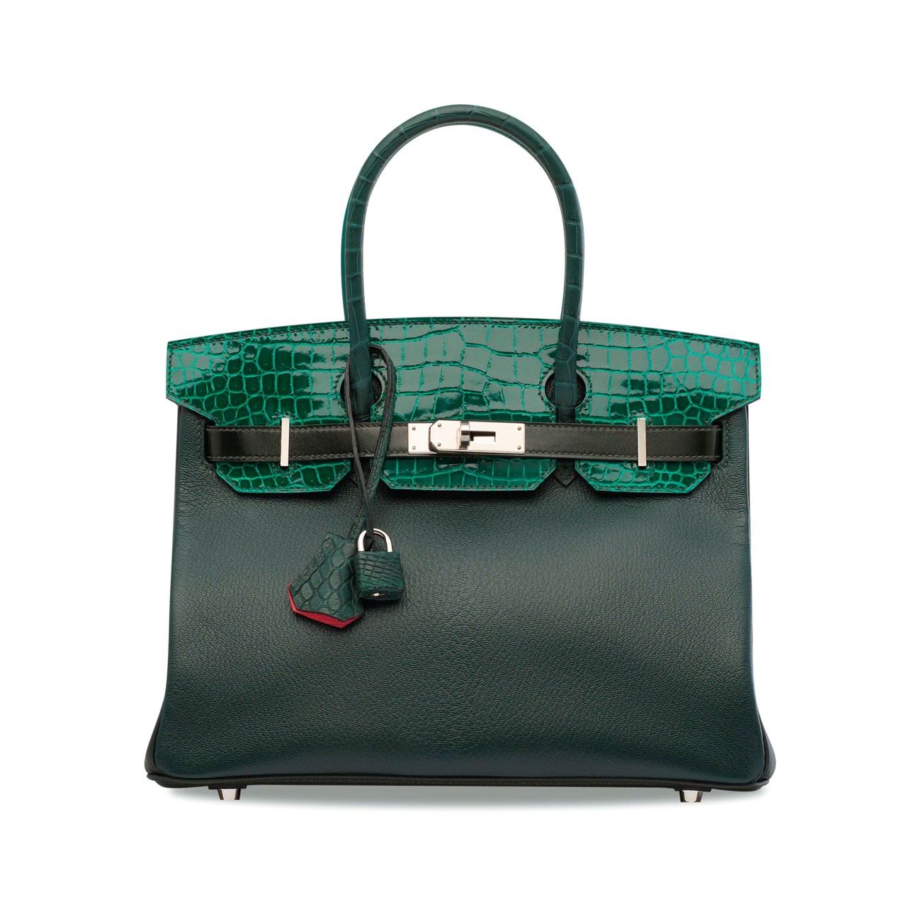 A green luxury handbag with a crocodile pattern on the flap and handles.