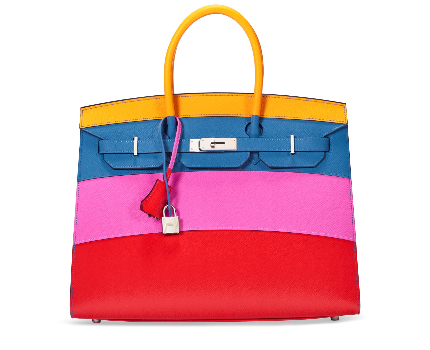A handbag with yellow handles and blue, pink, and red horizontal color blocks.