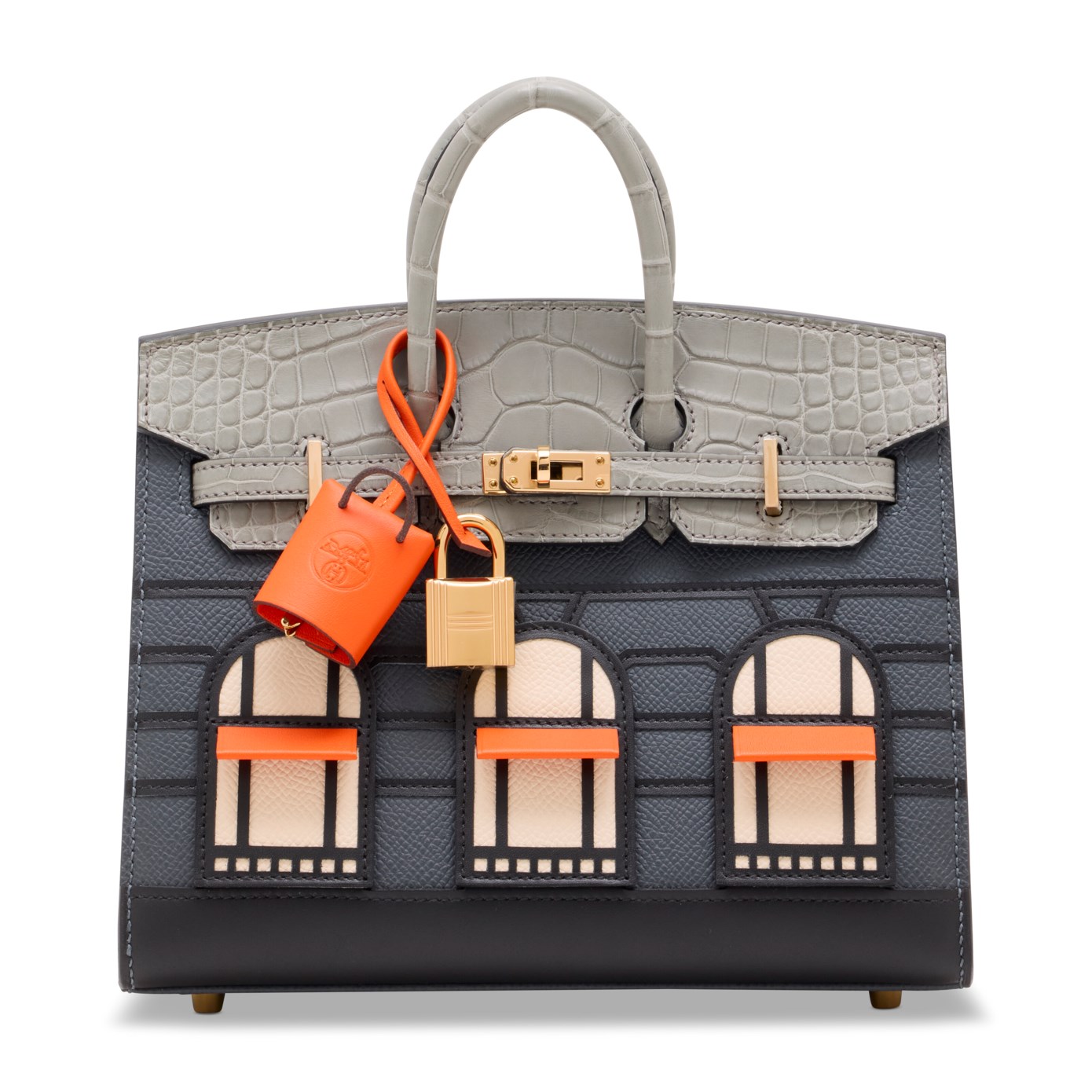 A luxury handbag designed to resemble a building facade with three arched windows and a gray top.