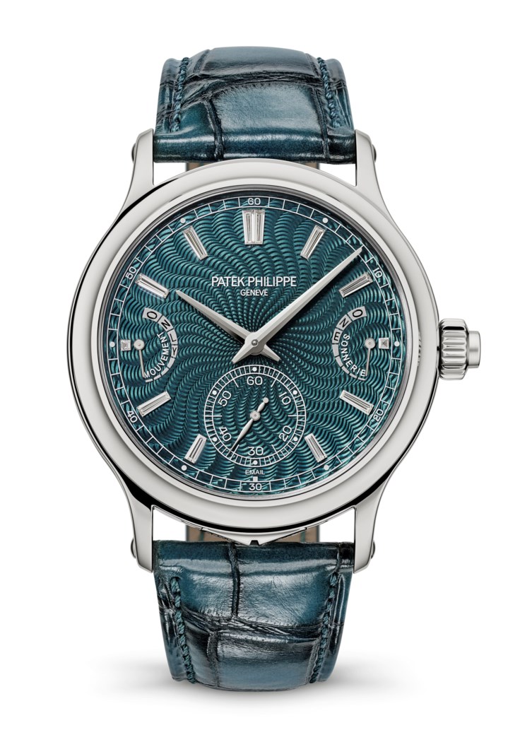 A luxurious Patek Philippe watch with a detailed teal guilloche dial, silver casing, and a matching teal leather strap.