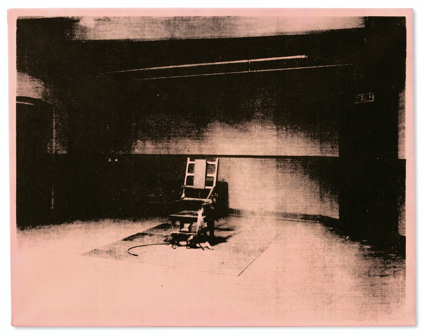 A dark, empty room with an electric chair in the center and cables on the floor.