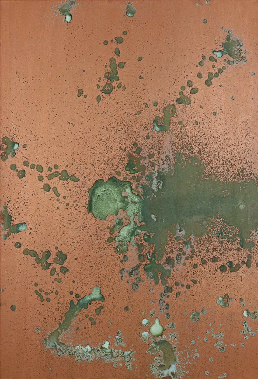 A rusty metal surface with patches of green corrosion and scattered spots.