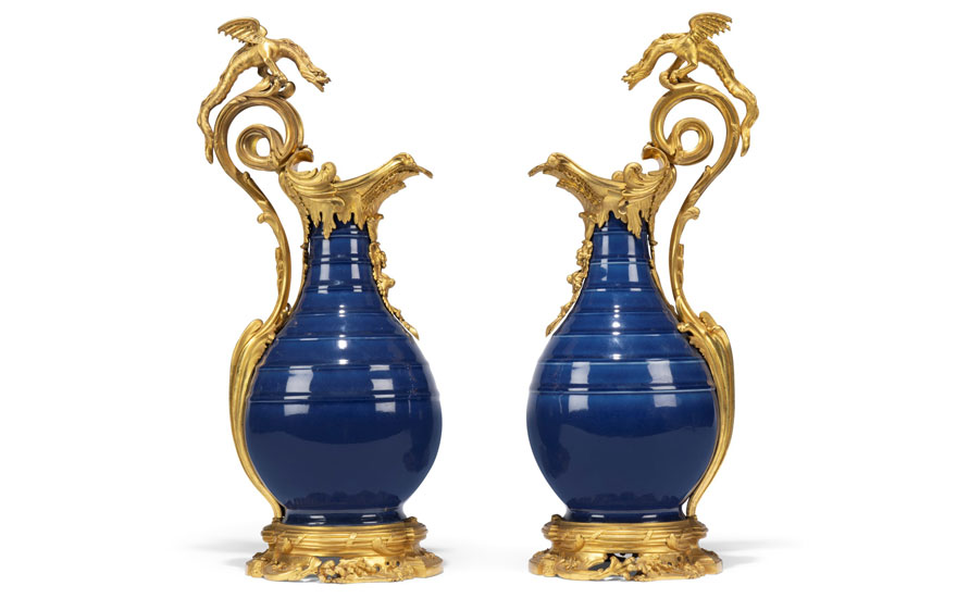 Two ornate blue vases with elaborate golden dragon handles and decorative bases.